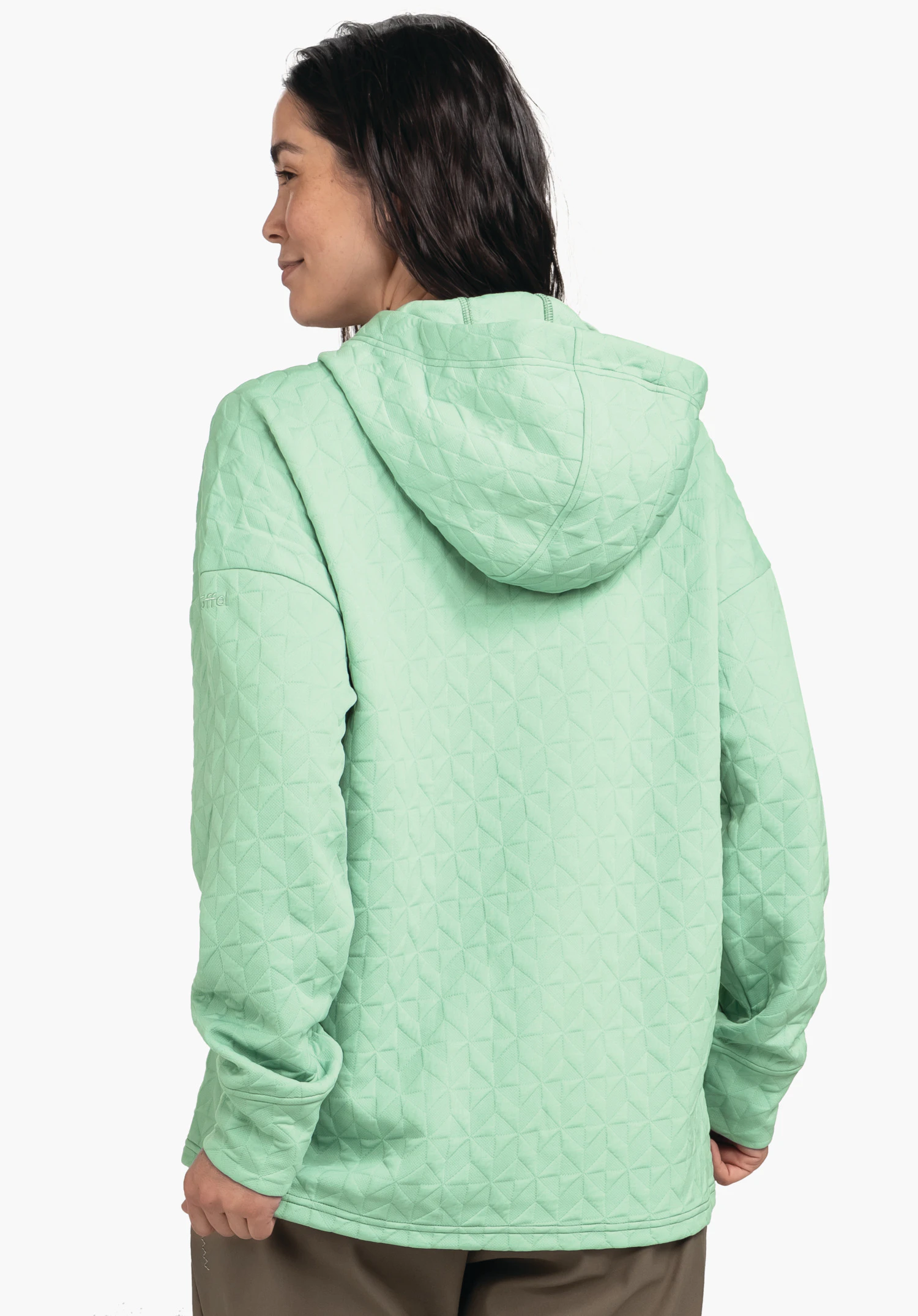 Hoody Style Vindave WMS lichtgroene gewatteerde hoodie, gedragen door een persoon die zich licht opzij draait en over de schouder kijkt; neutrale witte studioachtergrond.