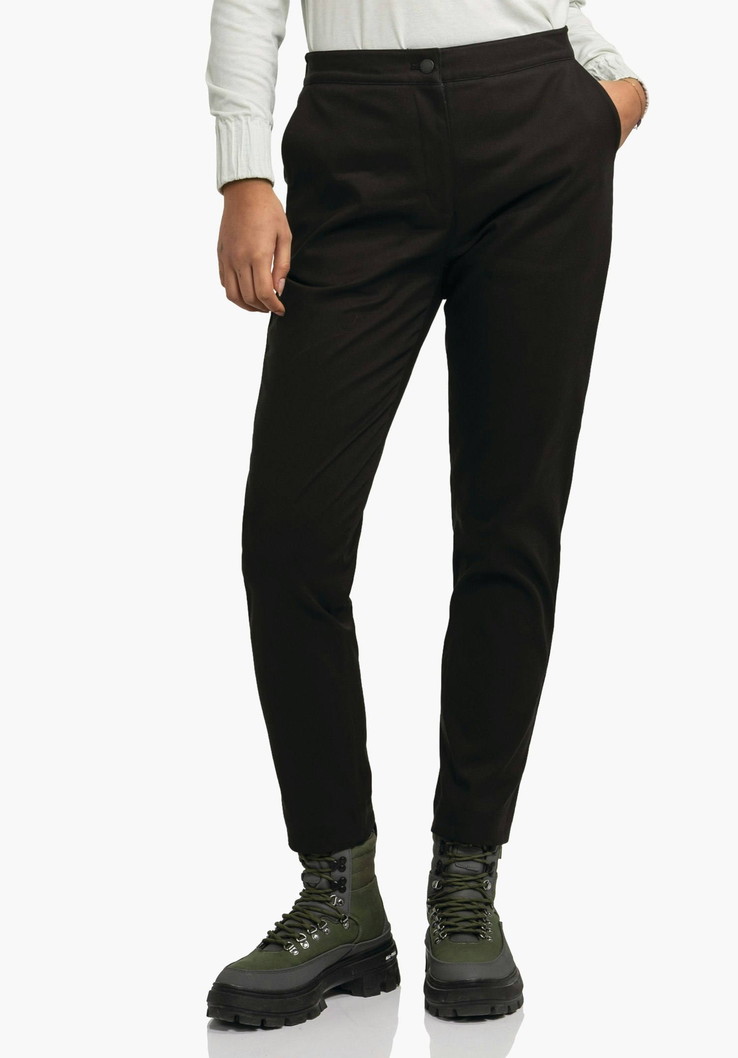 Pants Style Zourga WMS black tailored trousers worn standing upright; person has one hand in pocket; light background; dark green hiking boots with black soles visible.