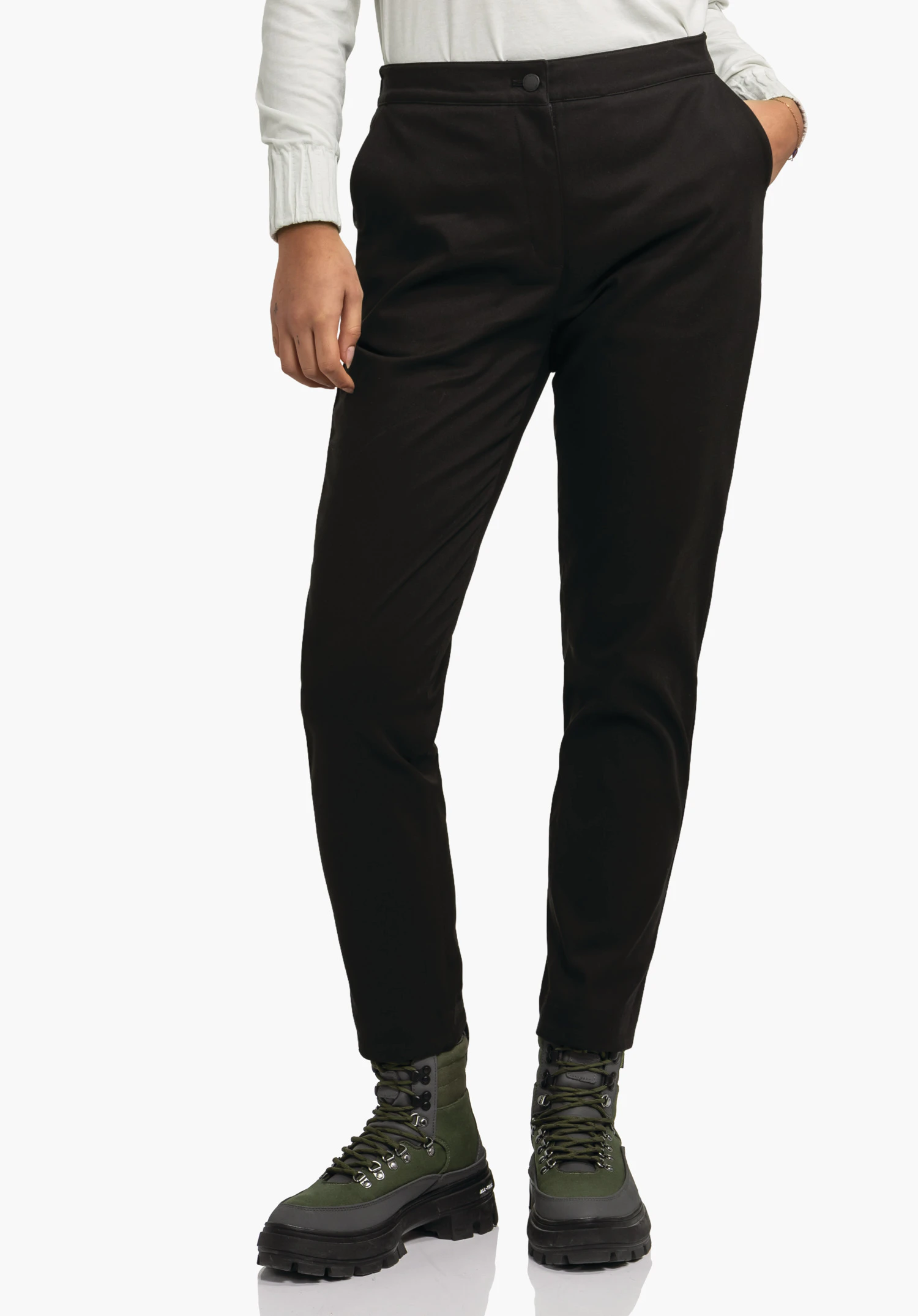 Pants Style Zourga WMS black tailored trousers worn standing upright; person has one hand in pocket; light background; dark green hiking boots with black soles visible.