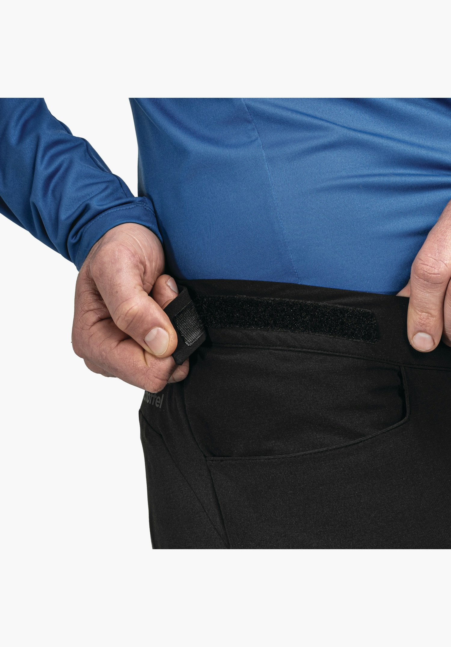 Pants Style Kubena MNS, the adjustable waistband with hook-and-loop fastener in black and the side-placed Schöffel logo, close-up against a white/neutral background.