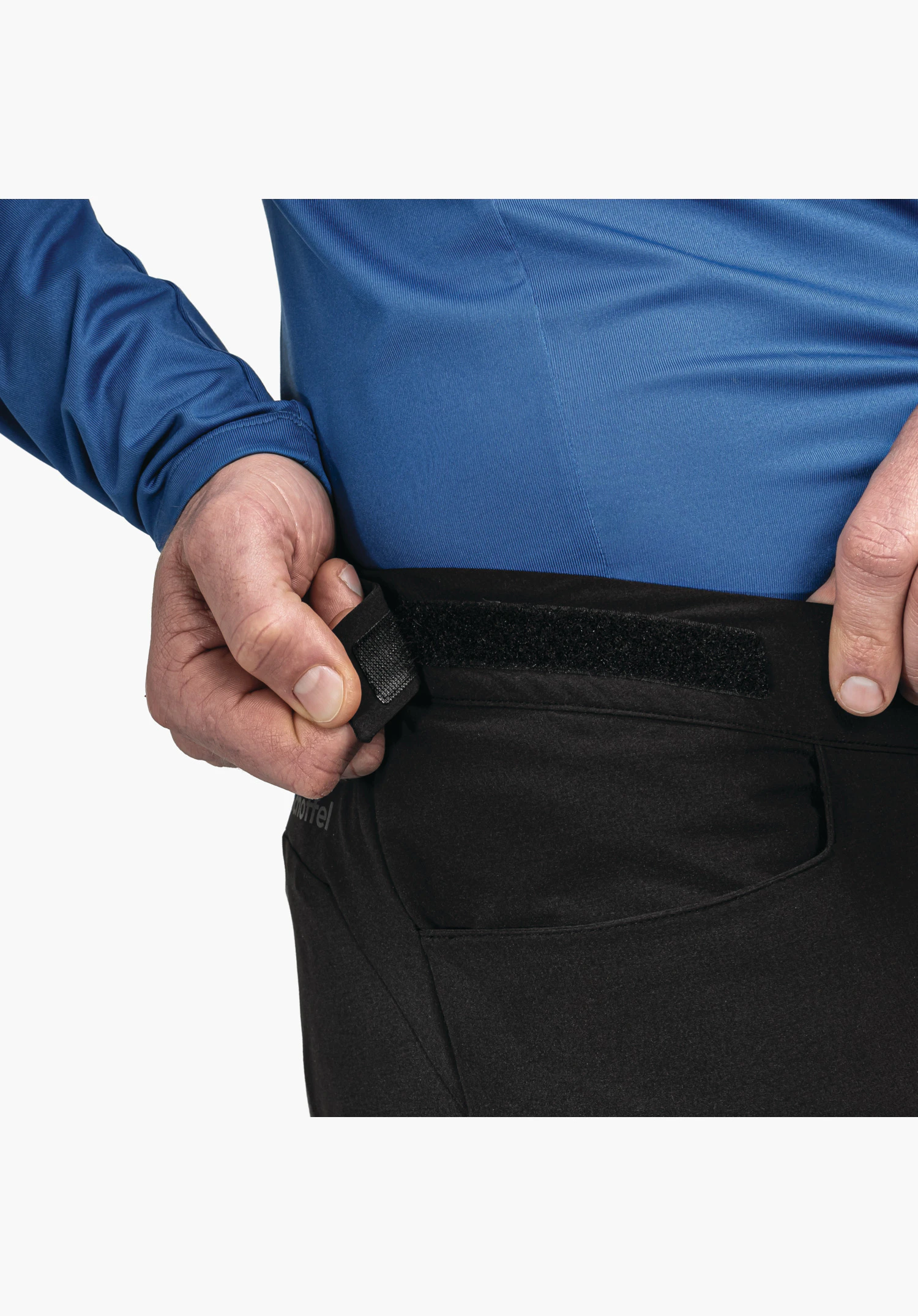 Pants Style Kubena MNS, the adjustable waistband with hook-and-loop fastener in black and the side-placed Schöffel logo, close-up against a white/neutral background.