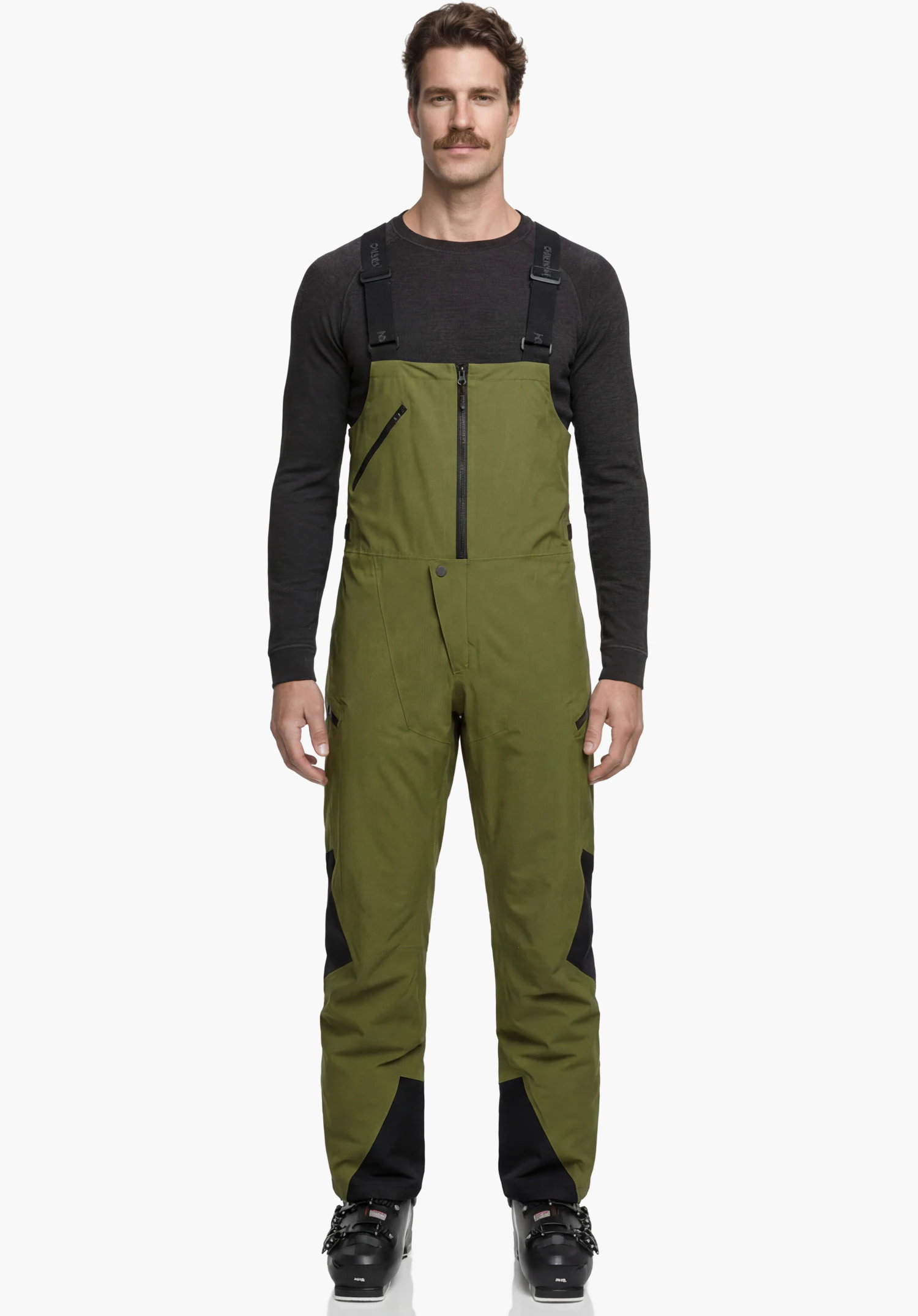 Pants Style Lufeld MNS in green showing the upper part of the bib and brace with a front zipper, a diagonal chest pocket, and the waistband with a snap button closure in a close-up against a white background.