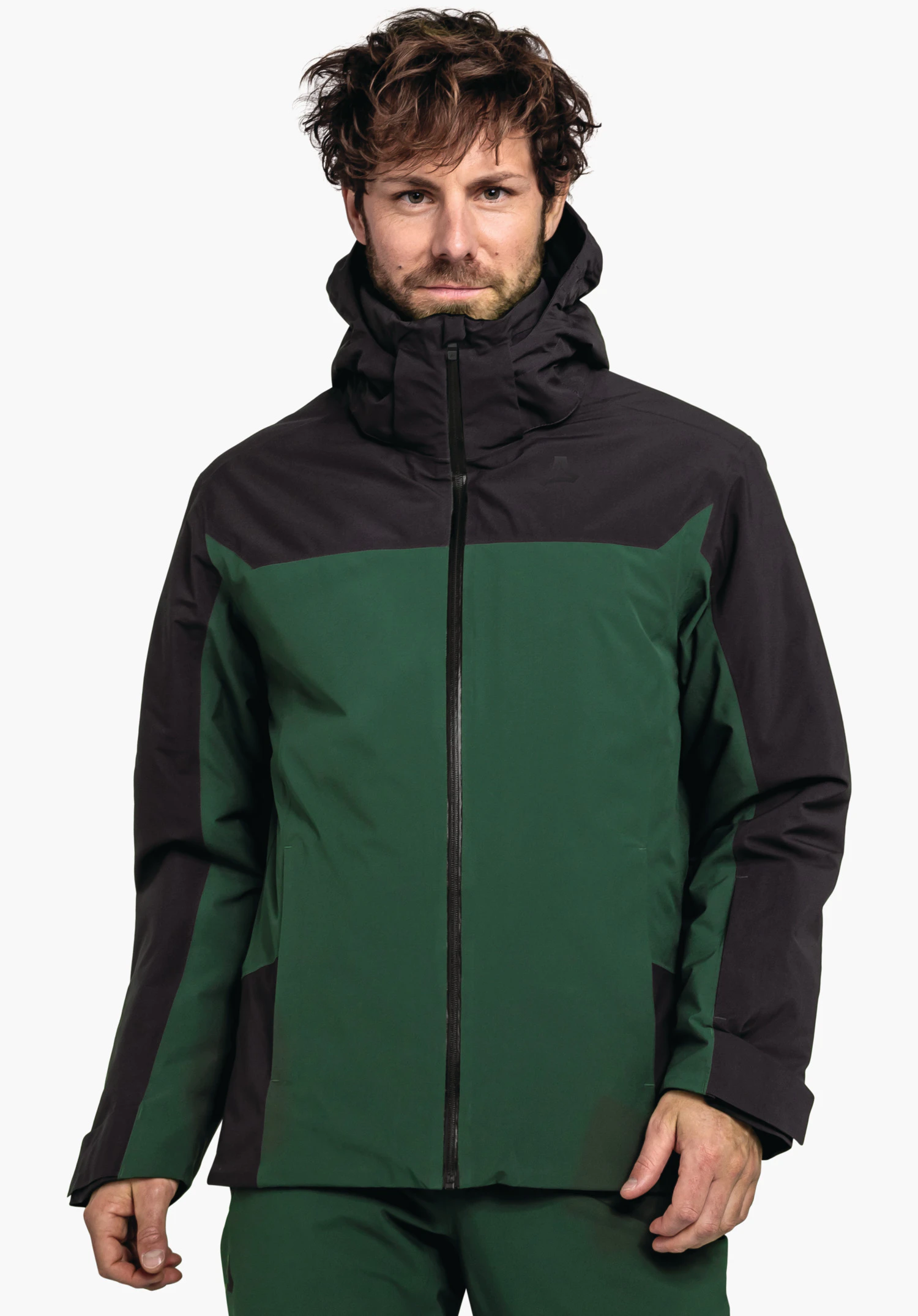 Jacket Style Zandwel MNS veste vert foncé avec épaules noires et capuche, portée par un homme debout; logo Schöffel sur la poitrine gauche; fond blanc.