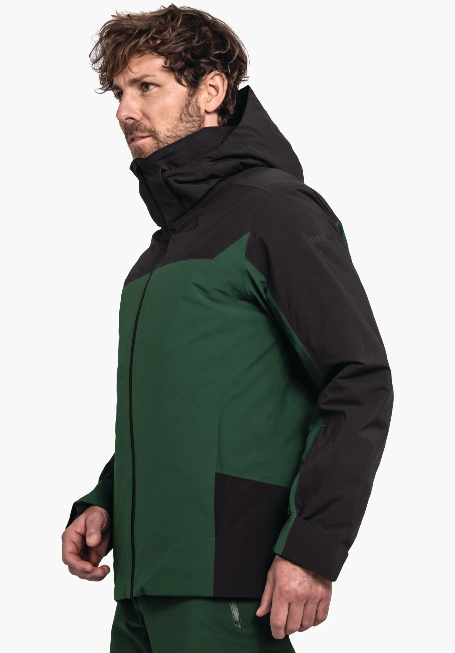 Jacket Style Zandwel MNS dark green and black jacket, worn by a man looking to the left; standing studio shot against a light background. Text: "schöffel".
