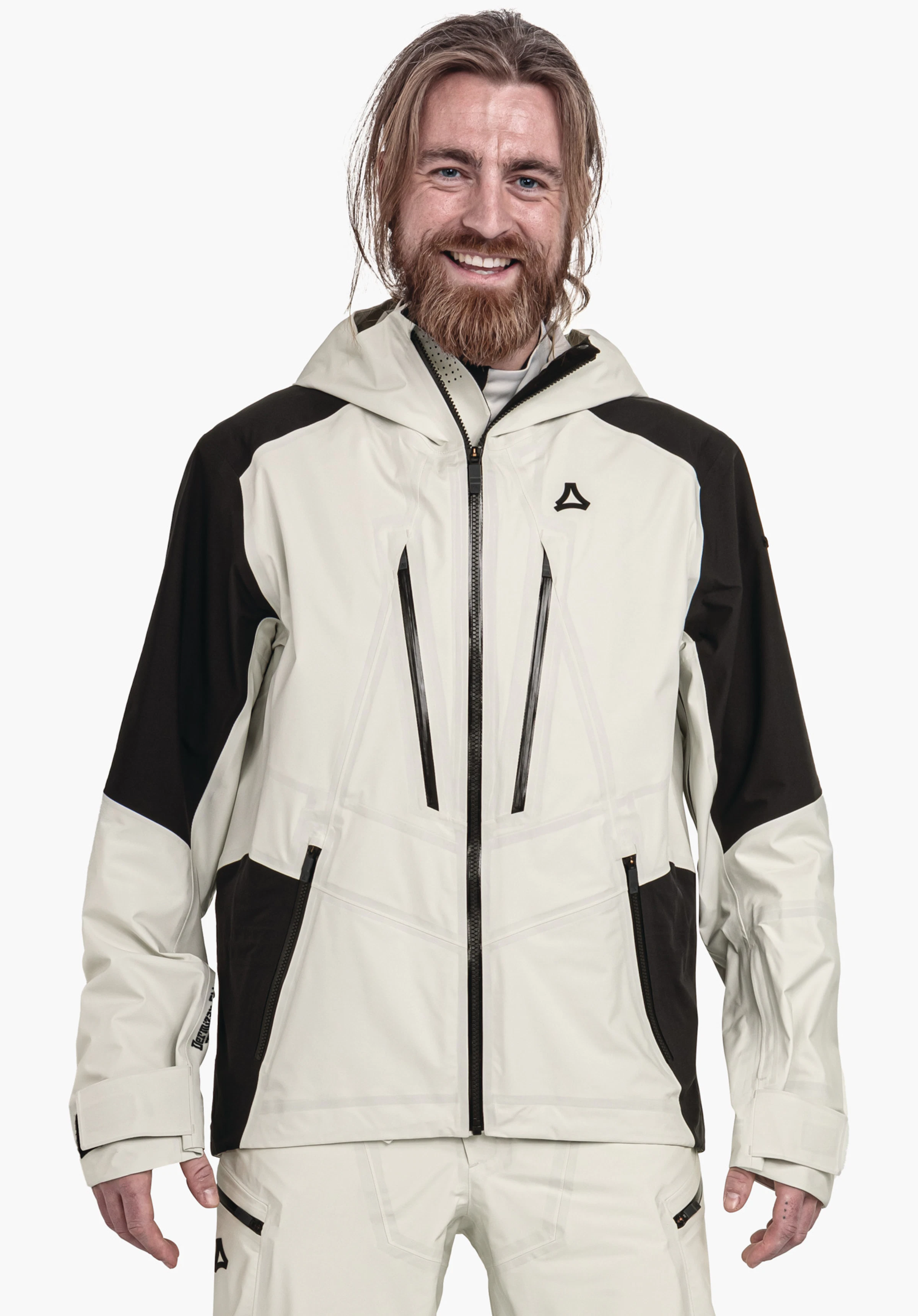 Shell Jk Style Lufeld MNS veste outdoor gris clair avec empiècements noirs, logo Schöffel sur la poitrine; personne la portant en souriant, debout de face devant un fond blanc neutre.