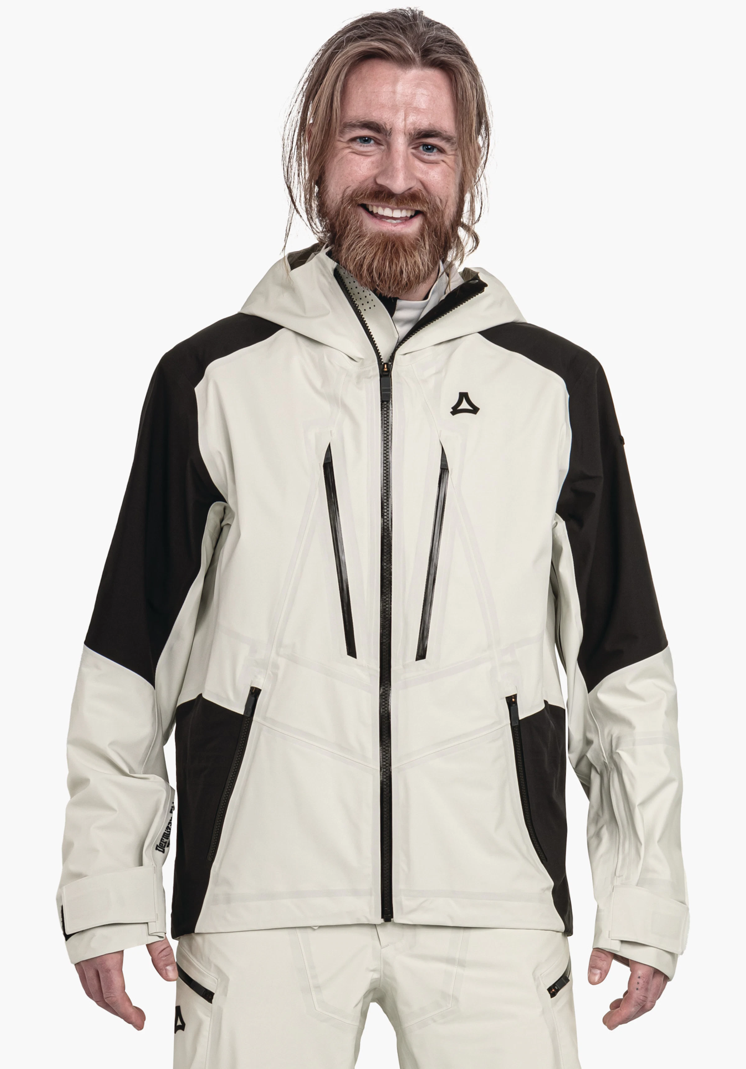 Shell Jk Style Lufeld MNS veste outdoor gris clair avec empiècements noirs, logo Schöffel sur la poitrine; personne la portant en souriant, debout de face devant un fond blanc neutre.