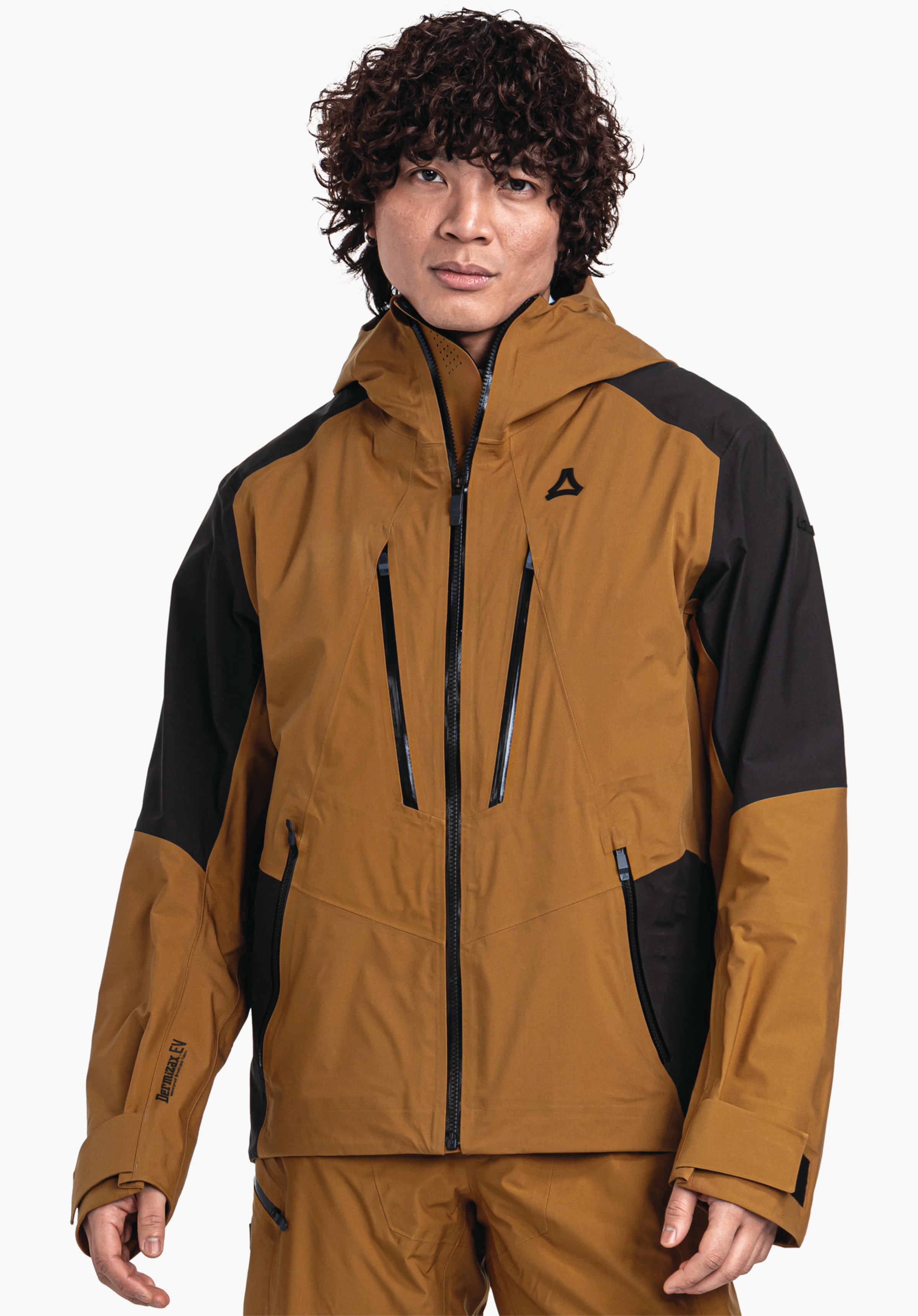 Shell Jk Style Lufeld MNS dunkelgelbe Jacke mit schwarzen Einsätzen, von einem Mann frontal getragen, Reißverschlüsse sichtbar, Kapuze hoch, vor weißem Hintergrund im Studio, mit Schöffel-Logo auf der Brust. Text: "Dermizax EV" (linker Unterarm).
