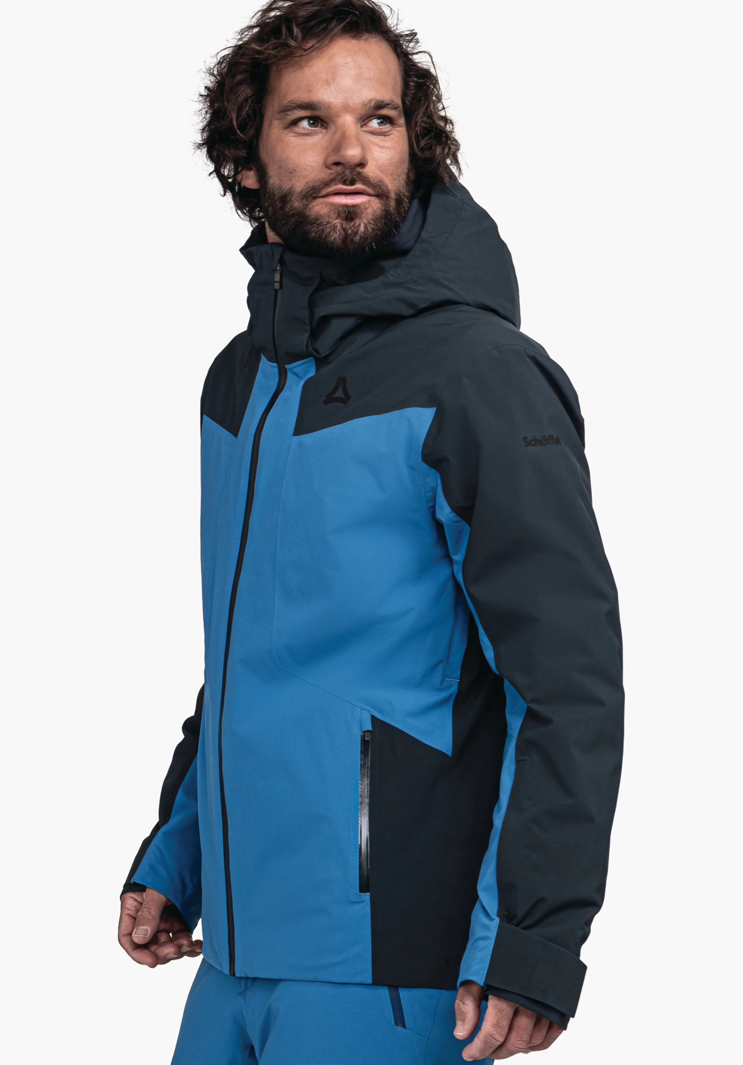 Jacket Style Trifex MNS blue and dark blue hooded jacket with Schöffel logo on the chest and lettering "Schöffel" on the sleeve; worn by a man looking sideways against a white studio background.