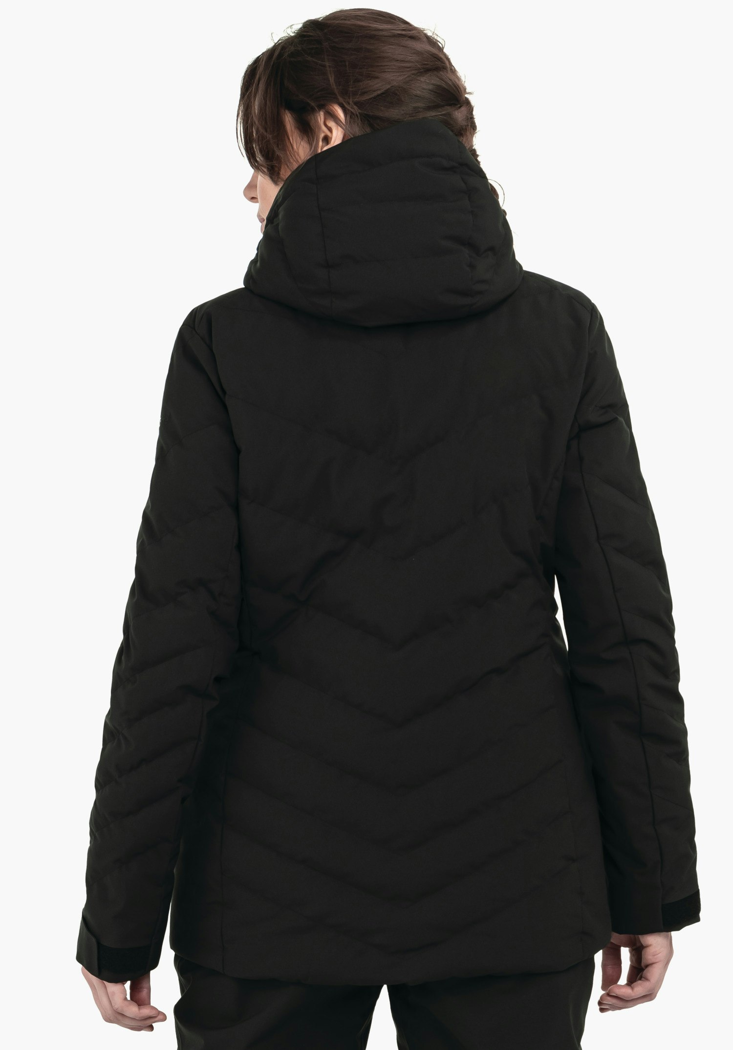 Jacket Style Alerce WMS black quilted hooded jacket worn by a person standing with back to the camera; dark brown hair; white background.