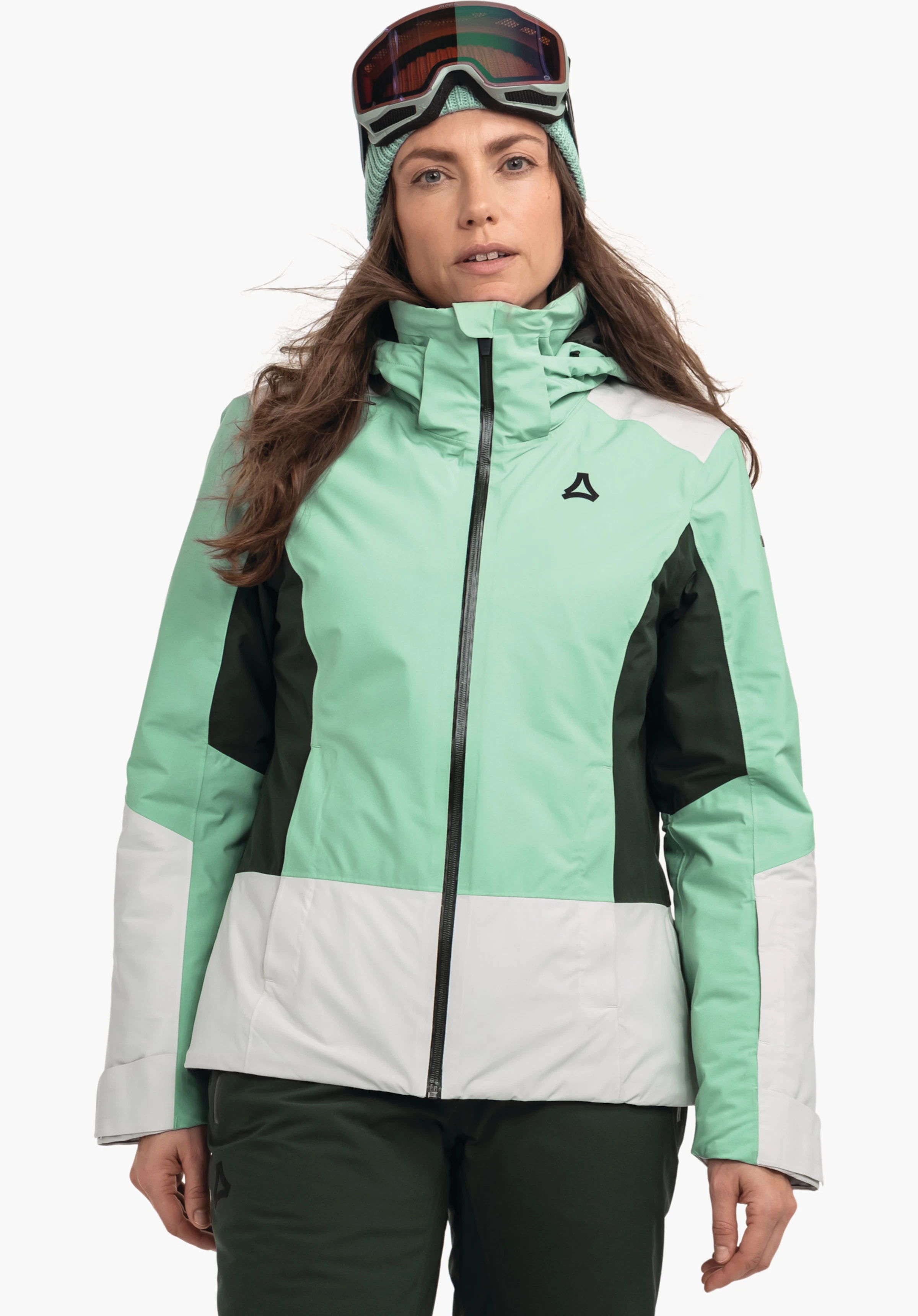 Jacket Style Zandwel WMS light green ski jacket with white hem and cuffs, dark green side panels and Schöffel logo on the chest; worn front-facing by a woman with ski goggles; white background.