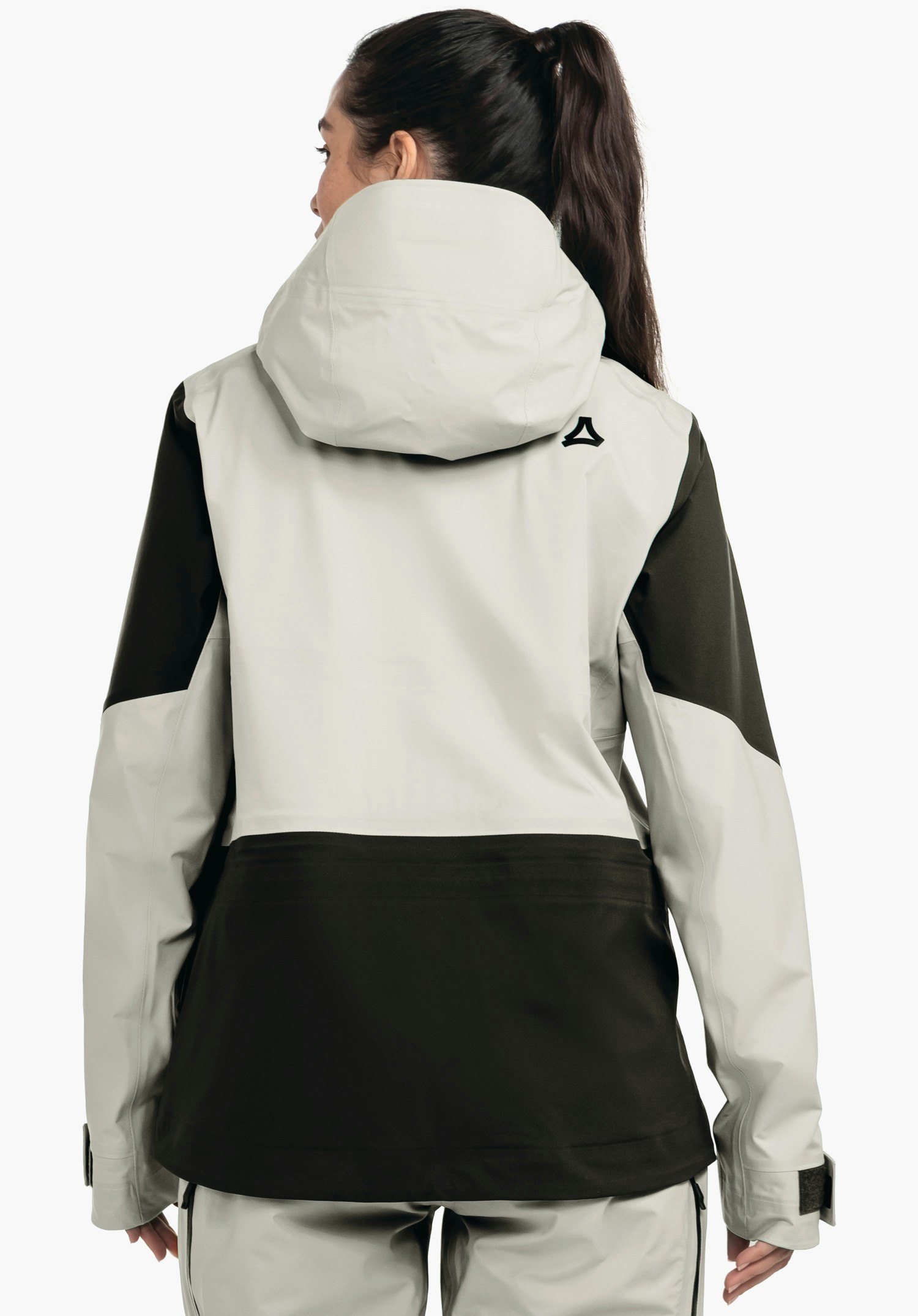 Shell Jk Style Lufeld WMS veste portée de dos: veste outdoor gris clair et vert foncé avec capuche, logo Schöffel sur l’épaule, femme regardant sur le côté, fond blanc.