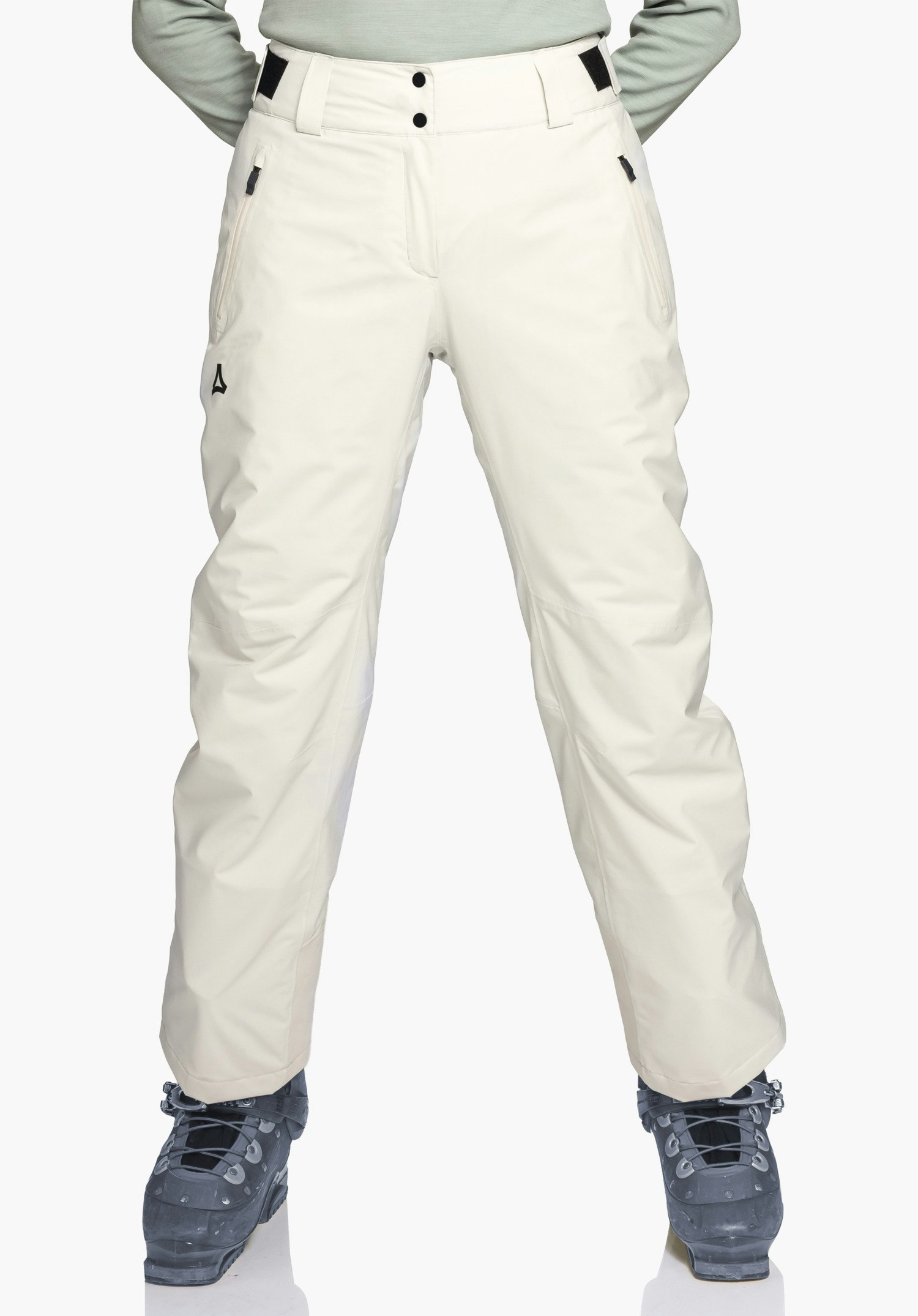Pants Style Pine WMS off-white ski trousers worn with slightly apart legs; waistband with two black press studs, side zip pockets and Schöffel logo on the outer thigh; worn over dark grey hiking boots against a light background.
