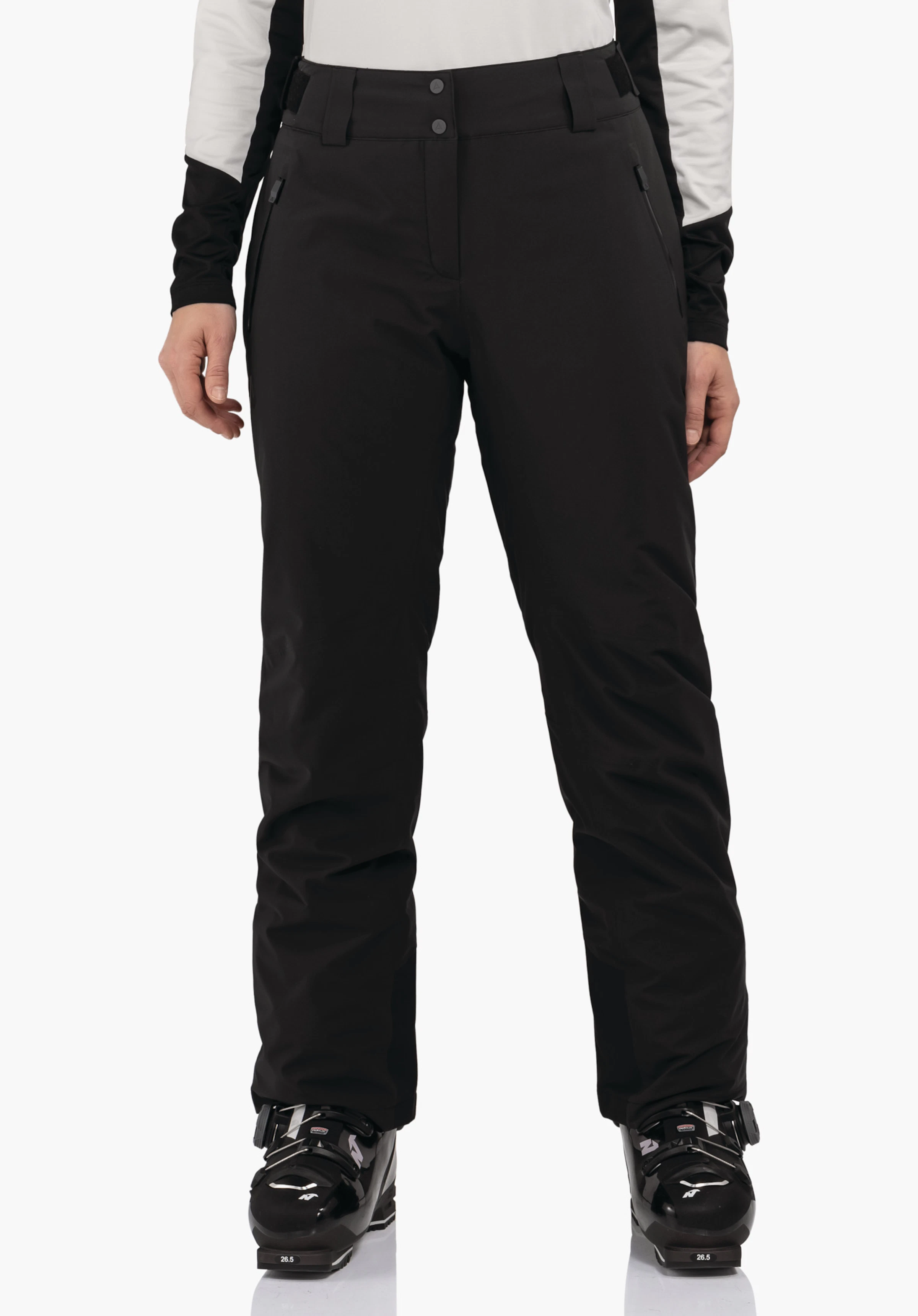 Pants Style Pine WMS black ski trousers worn by a standing model, photographed front-facing; white sleeves visible and black ski boots with “26.5” text; white background.