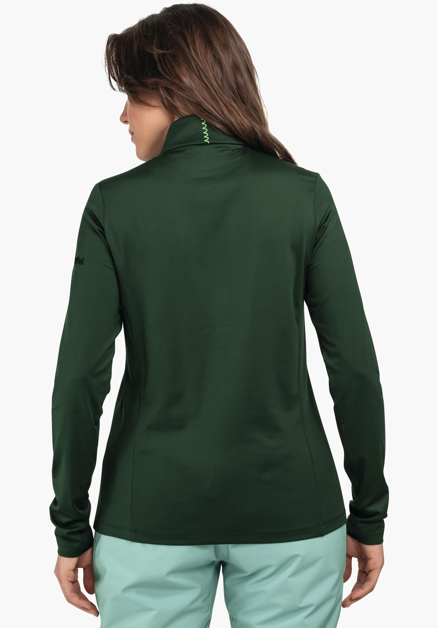 Longsleeve Style Pine WMS dark green long-sleeve jacket worn in rear view; collar with light green zigzag stitching; light turquoise trousers; neutral white background. Text: “Schöffel”.