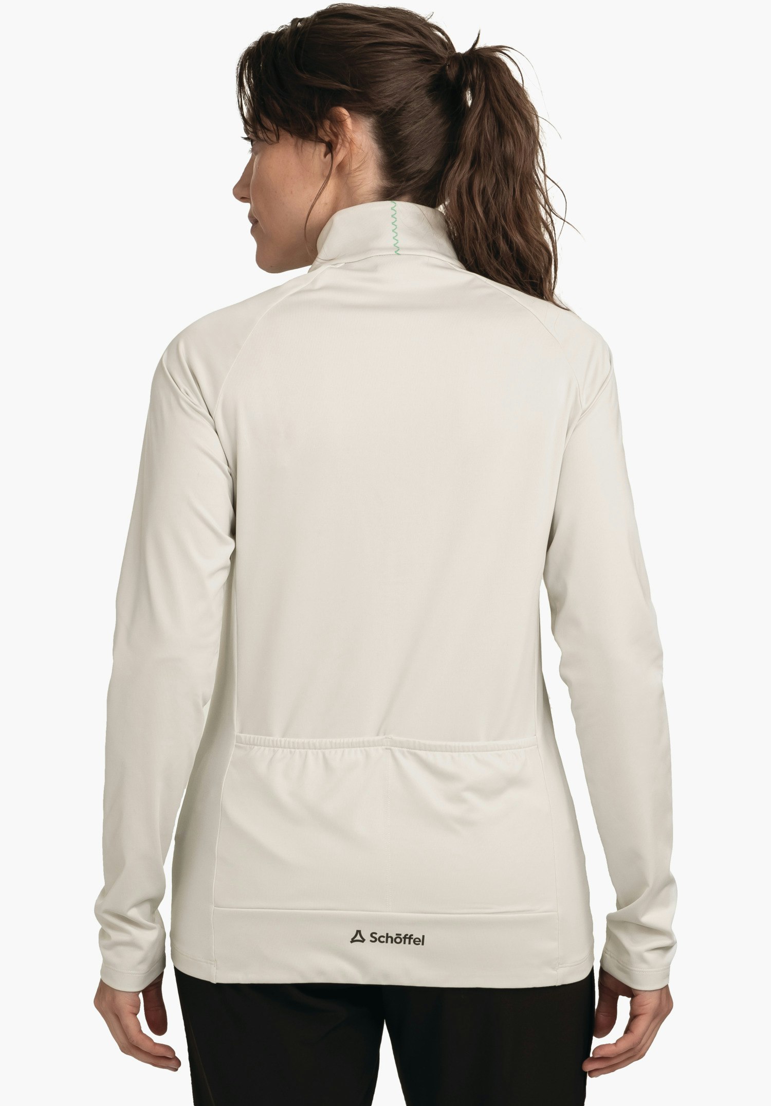 Longsleeve Style Kubena WMS close-fitting jacket worn by a woman standing with her back to the camera; neutral studio background; Schöffel logo and “Schöffel” lettering at the hem.