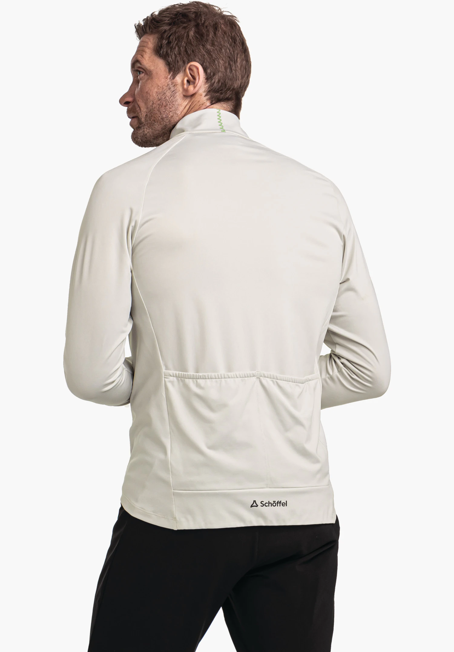 Longsleeve Style Kubena MNS off-white men’s jacket worn from the back; hands at hip height, rear pockets visible; Schöffel logo and “Schöffel” lettering at the hem; neutral white background.
