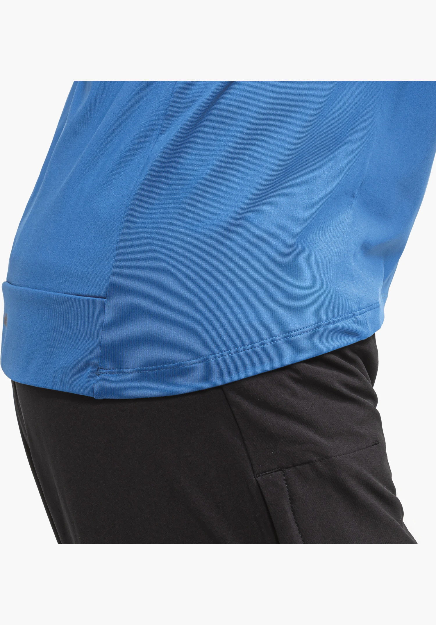 Longsleeve Style Kubena MNS shows the rounded hem and the blue fabric structure, close-up against a white/neutral background.