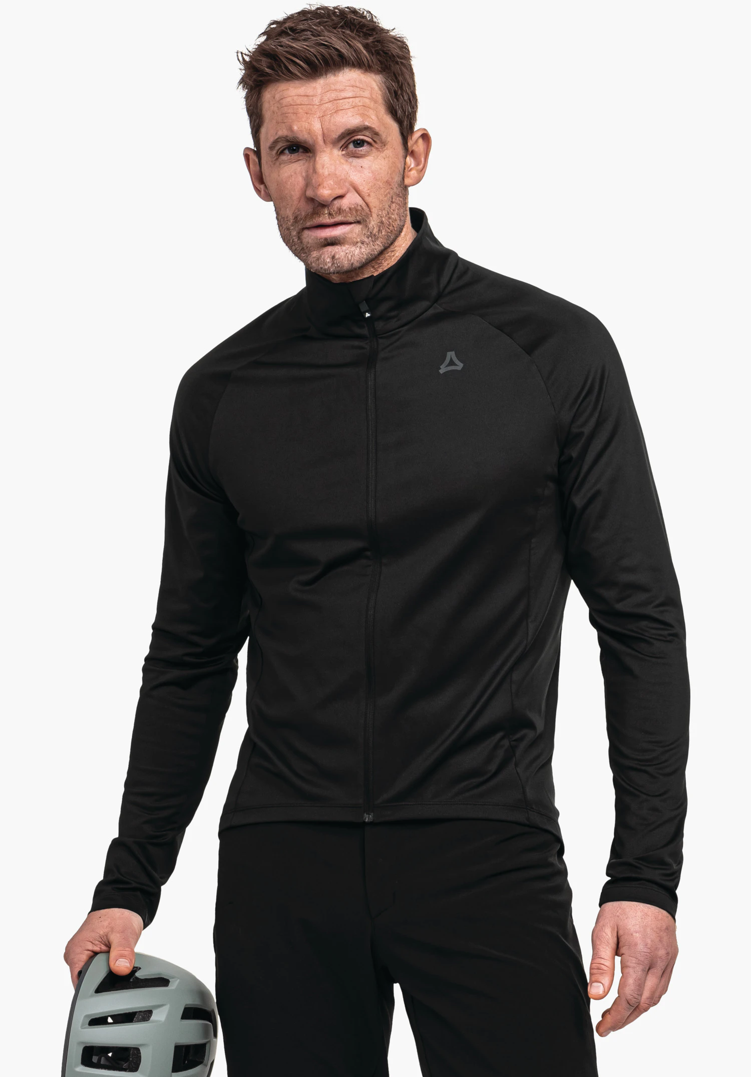 Longsleeve Style Kubena MNS black sports jacket worn by a man with zip closed; he holds a light grey bicycle helmet in the left hand; Schöffel logo on the left chest; white background.