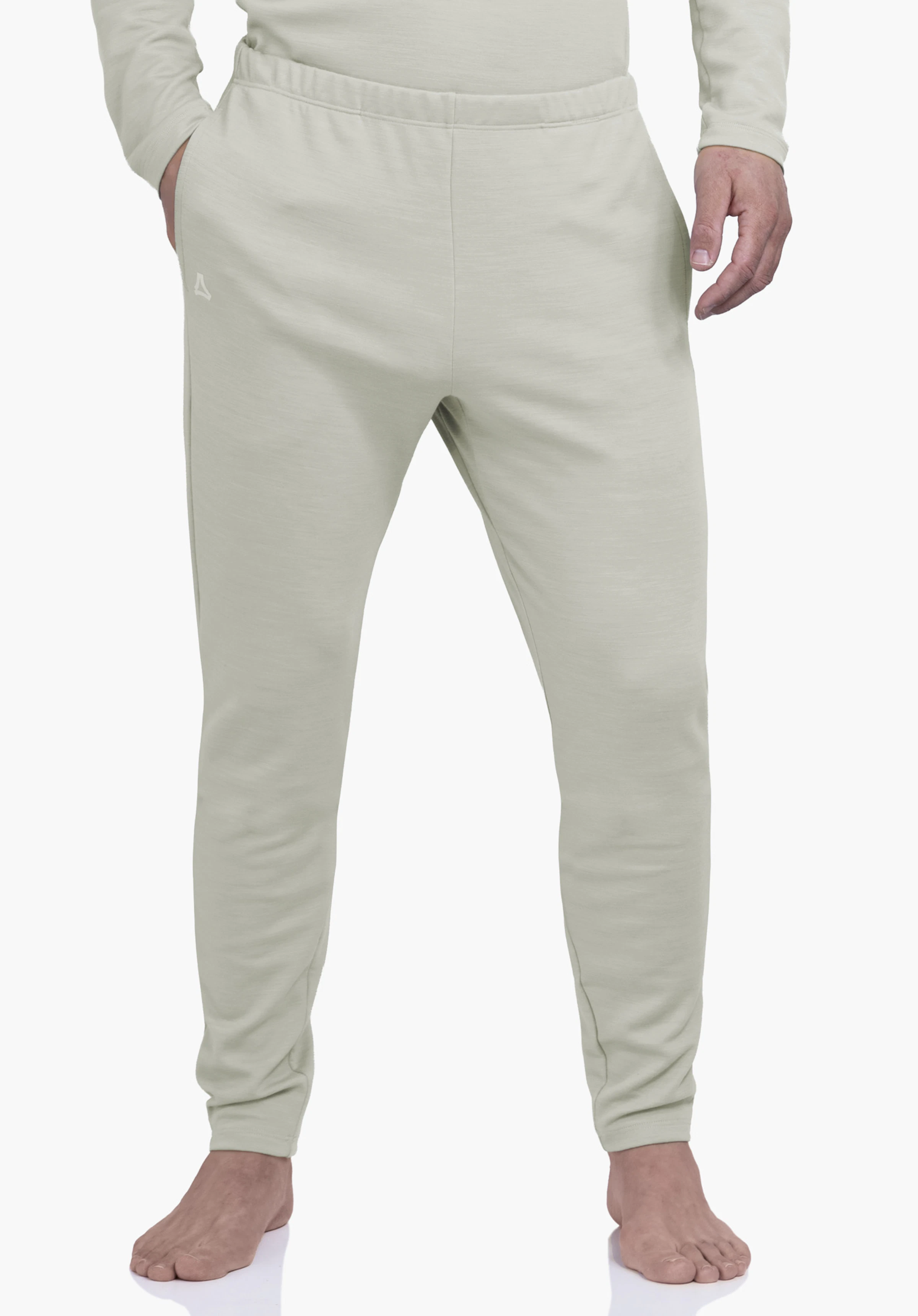 Pants Style Canyfer MNS Jogginghose: schlanke hell grüne Hose mit Schöffel-Logo, stehend, Hände in Taschen, Beine leicht auseinander, vor neutralem Hintergrund.