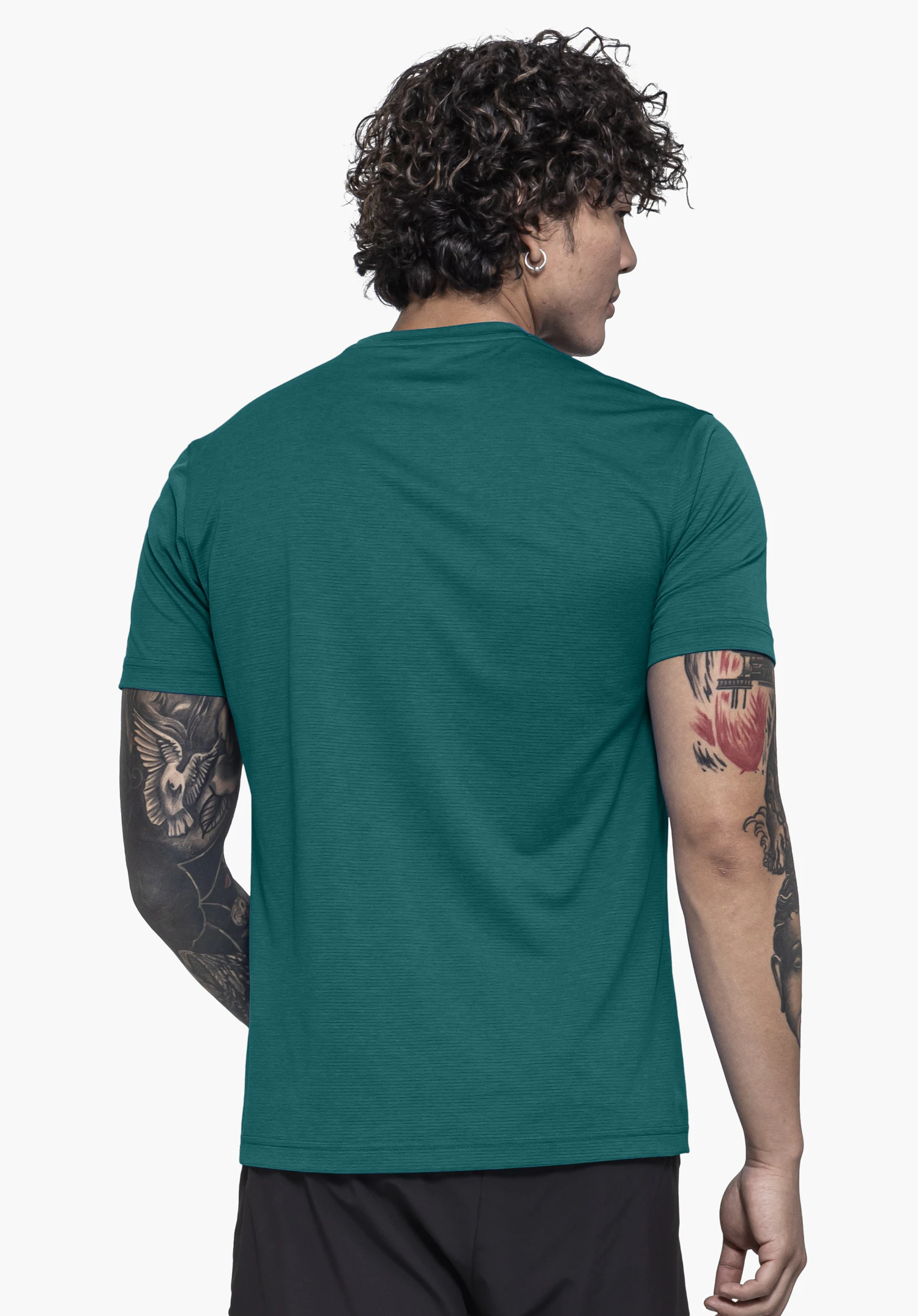 T Shirt Style Chipoma MEN in green. The model is shown from a rear view against a neutral background, highlighting the clean design and fit of the garment.