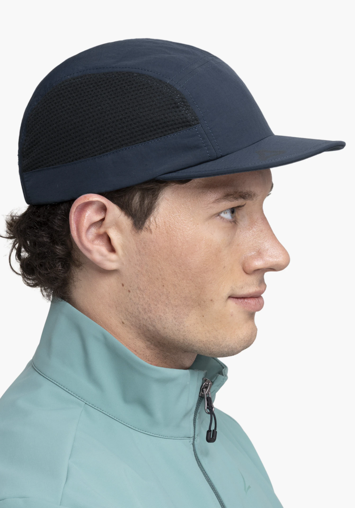 Cap Style Mauku UNI, worn by a model in a side profile view, showcasing the blue design with mesh inserts and the Schöffel logo on the peak against a neutral background.