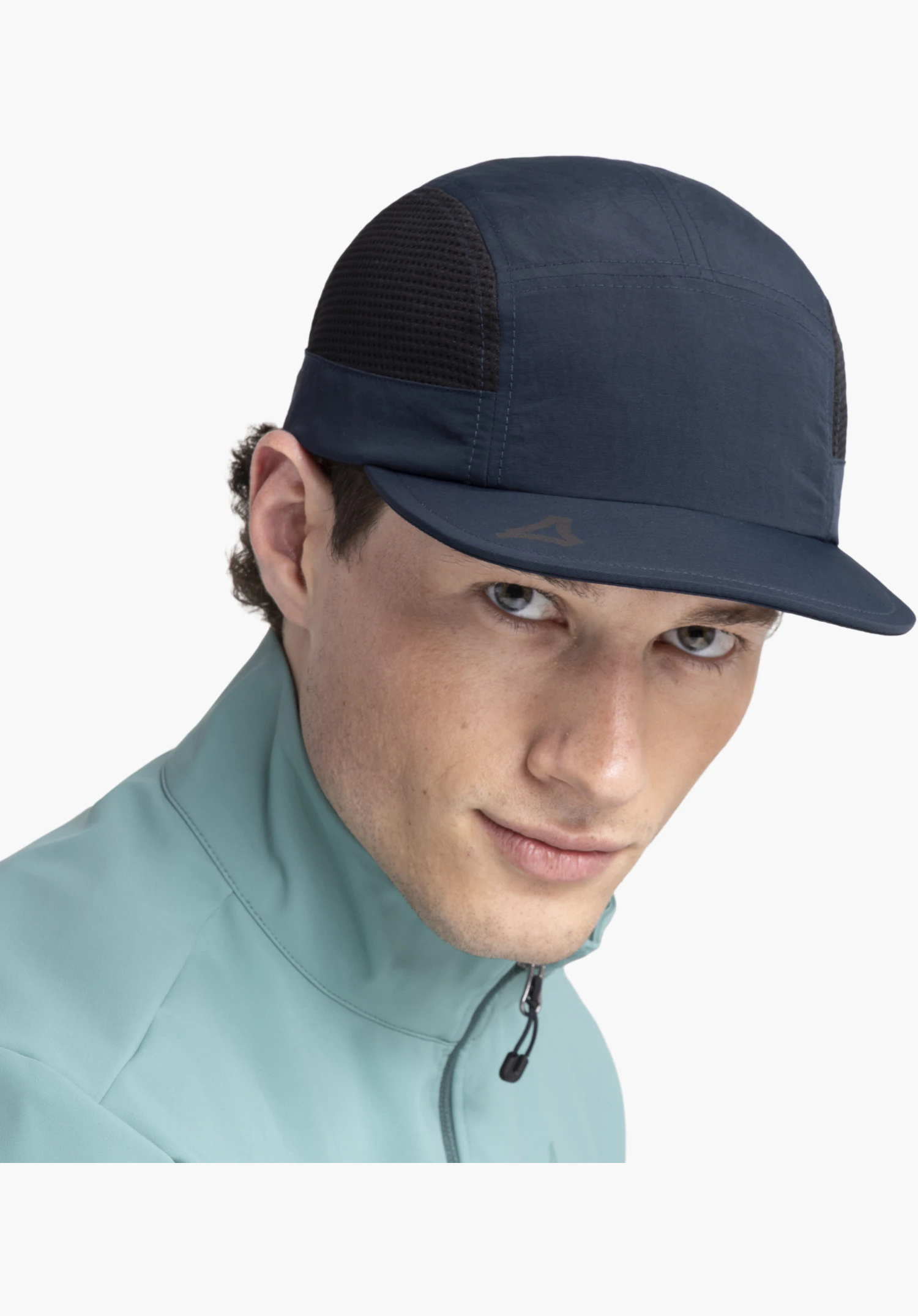 Cap Style Mauku UNI, focusing on the blue peak with a subtle Schöffel-Logo and the black mesh insert on the side, close-up against a white/neutral background.