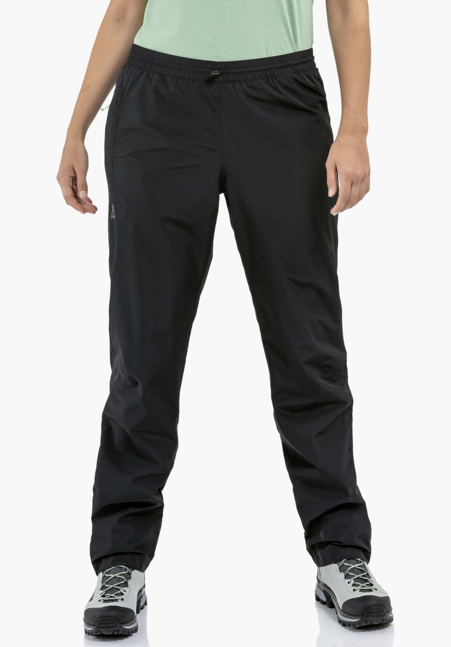 Rain Pants Style Elmori UNI, focusing on the elasticated waistband and the smooth black fabric with the subtle Schöffel-Logo on the leg, in a close-up against a white background.
