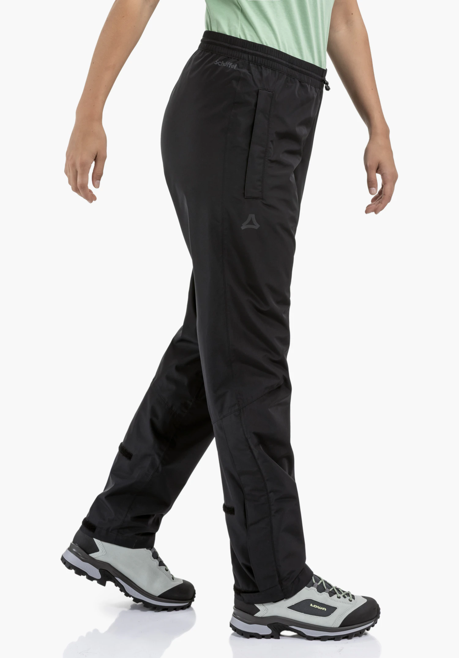 Rain Pants Style Elmori UNI montre la taille élastiquée, la poche latérale et le Schöffel-Logo sur le tissu noir, gros plan sur fond blanc/neutre.