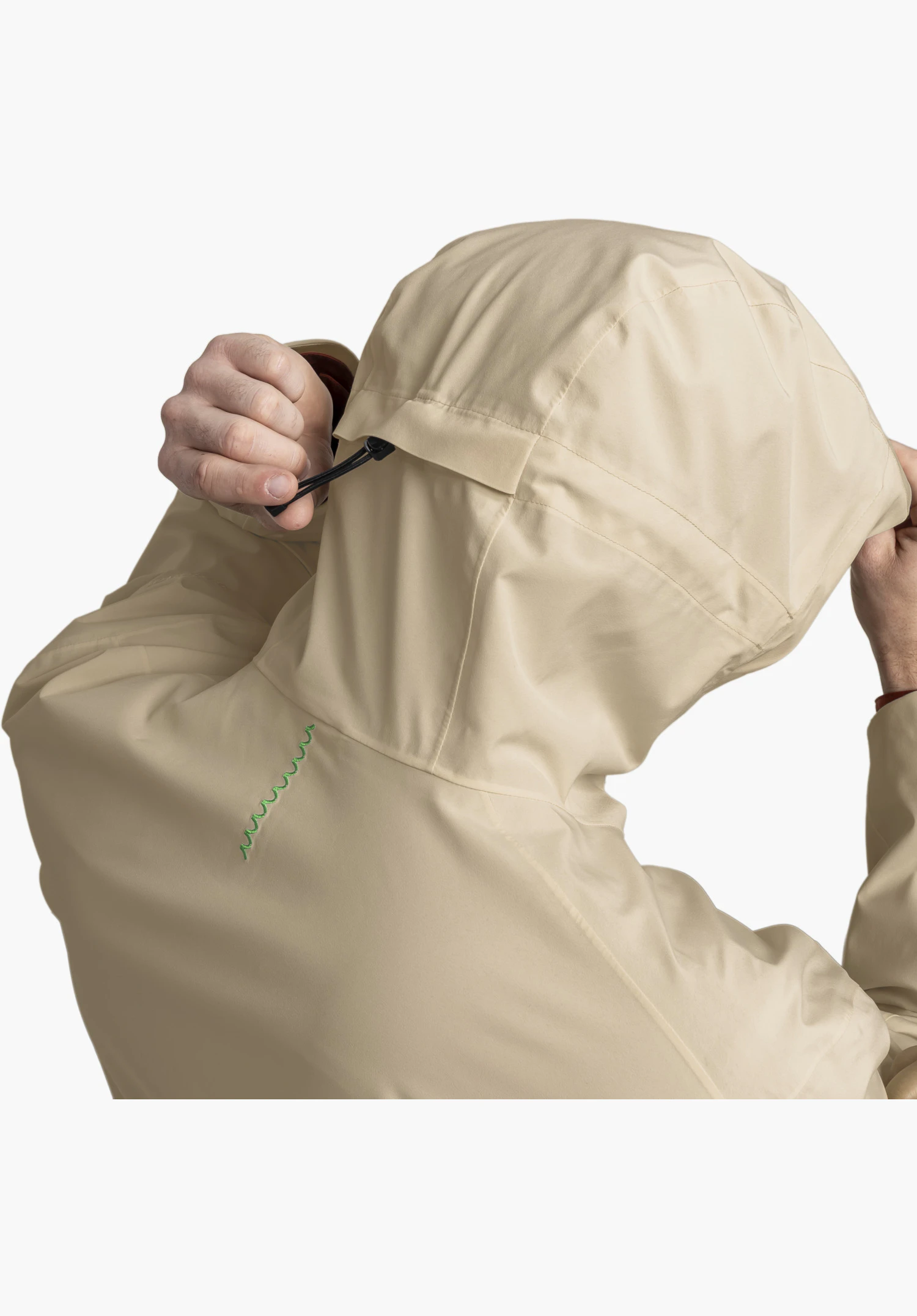 CIRC Jacket Style Smue MEN shows the rear hood adjustment with a black drawcord and a distinctive wavy green embroidered detail on the beige fabric, close-up against a white/neutral background.