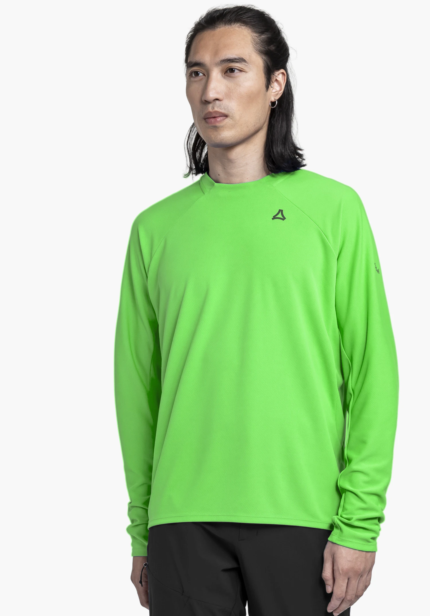 Longsleeve Style Enixa MEN worn by a model standing slightly sideways. The green shirt features the Schöffel logo on the left chest, photographed against a neutral background.