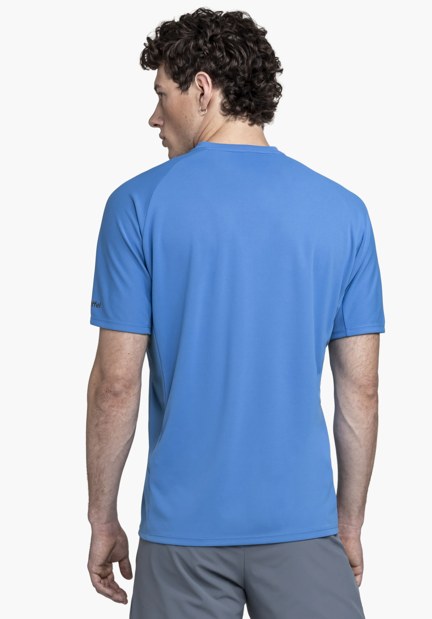 T Shirt Style Enixa MEN in blue is shown here in a rear view against a neutral background. The focus is on the athletic cut, while the subtle Schöffel logo on the sleeve ensures an authentic look.
