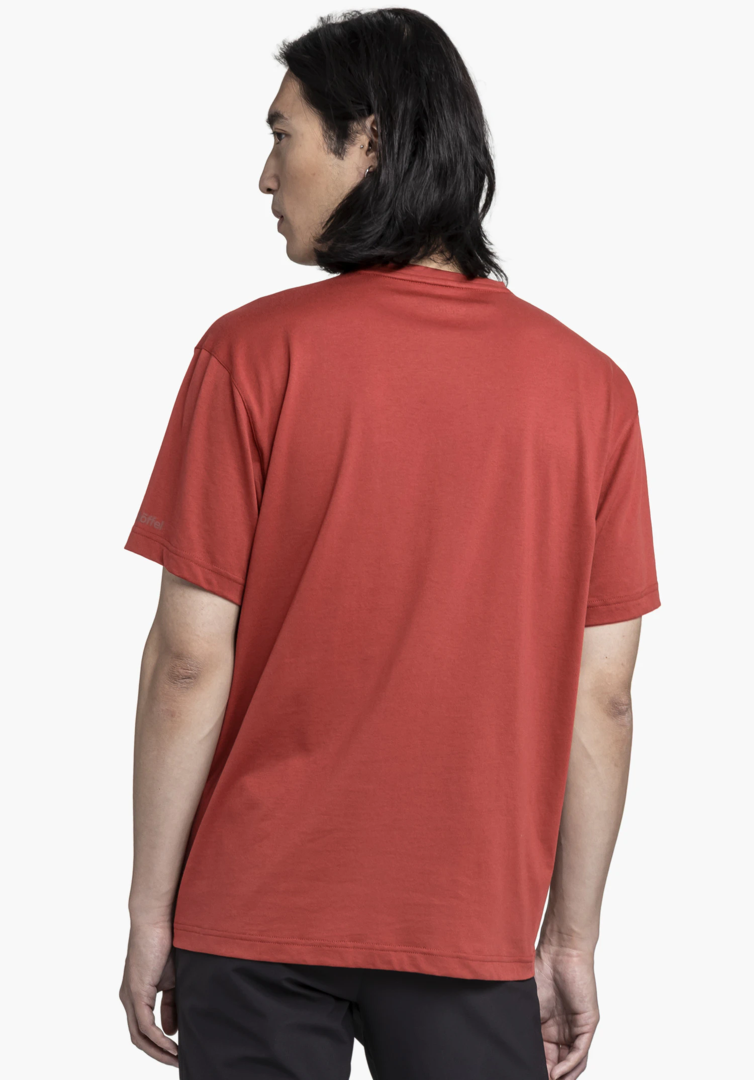 T Shirt Style Elmori MEN in red set against a neutral background. The model is shown from the back, looking slightly to the side, with the subtle Schöffel logo visible on the sleeve.
