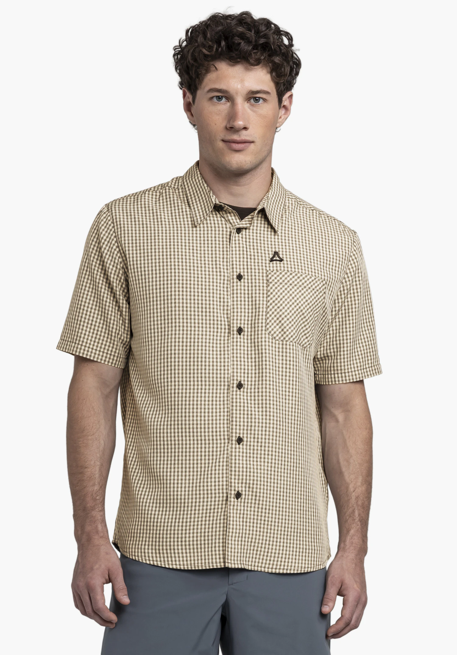 CIRC Shirt Style Dalfoss MEN: A model stands frontally in front of a neutral background, showcasing the checkered shirt. The prominent black Schöffel logo on the chest pocket emphasizes the high-quality design.