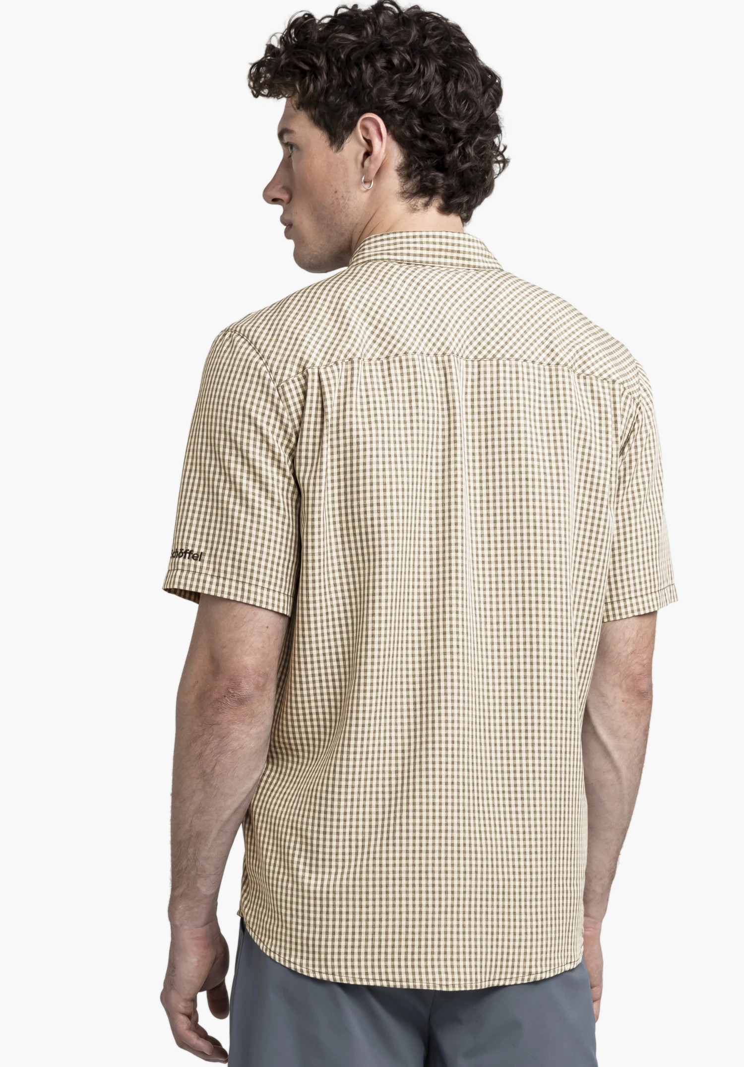 CIRC Shirt Style Dalfoss MEN in black. The male model is shown from a back perspective with his head slightly turned, posing against a neutral background. The high-quality fit and the Schöffel logo on the sleeve are clearly visible.