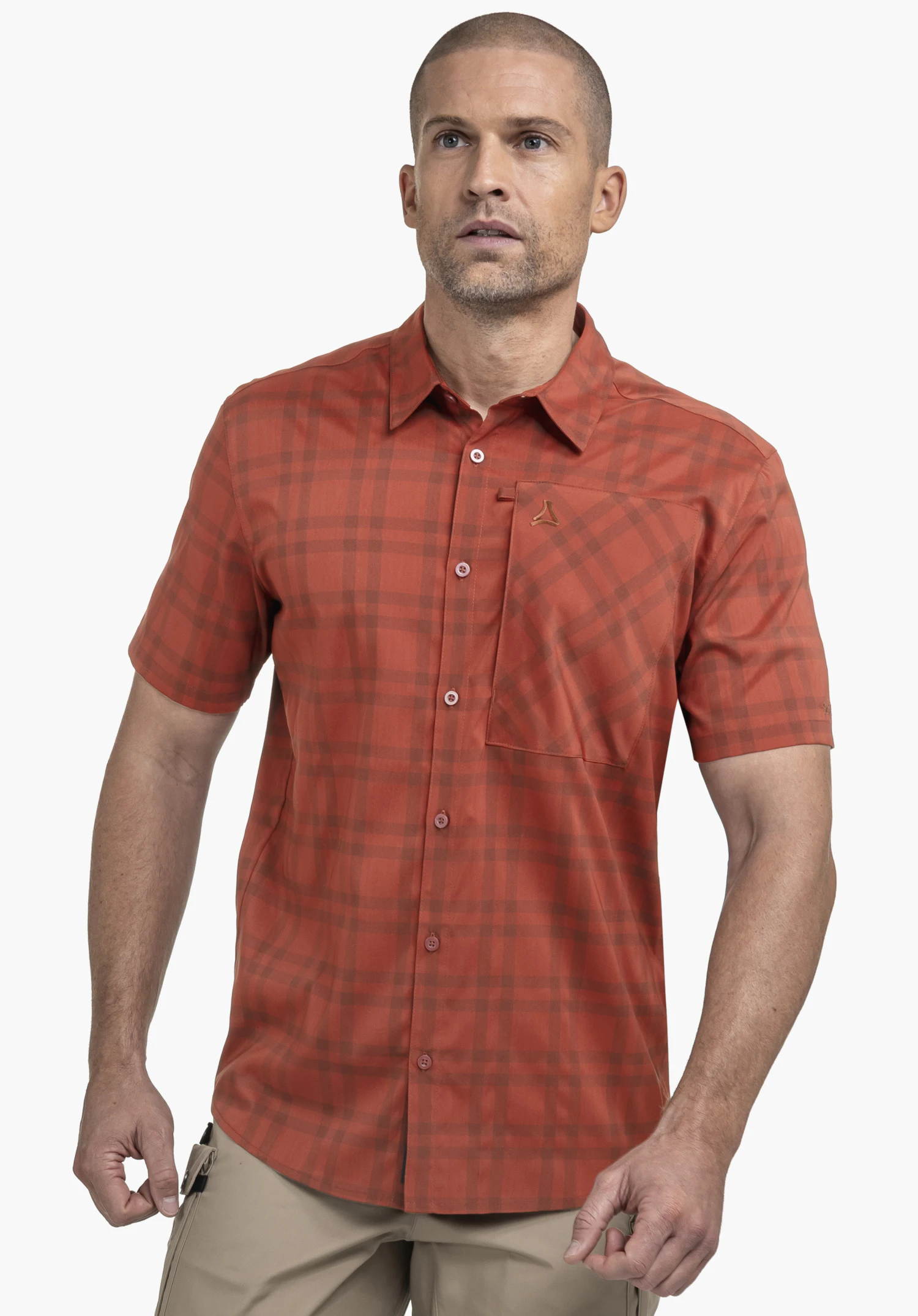 Shirt Style Frolya MEN in red. The model stands frontally against a neutral background, showcasing the short-sleeved checked shirt. The subtle Schöffel logo is visible on the chest pocket.