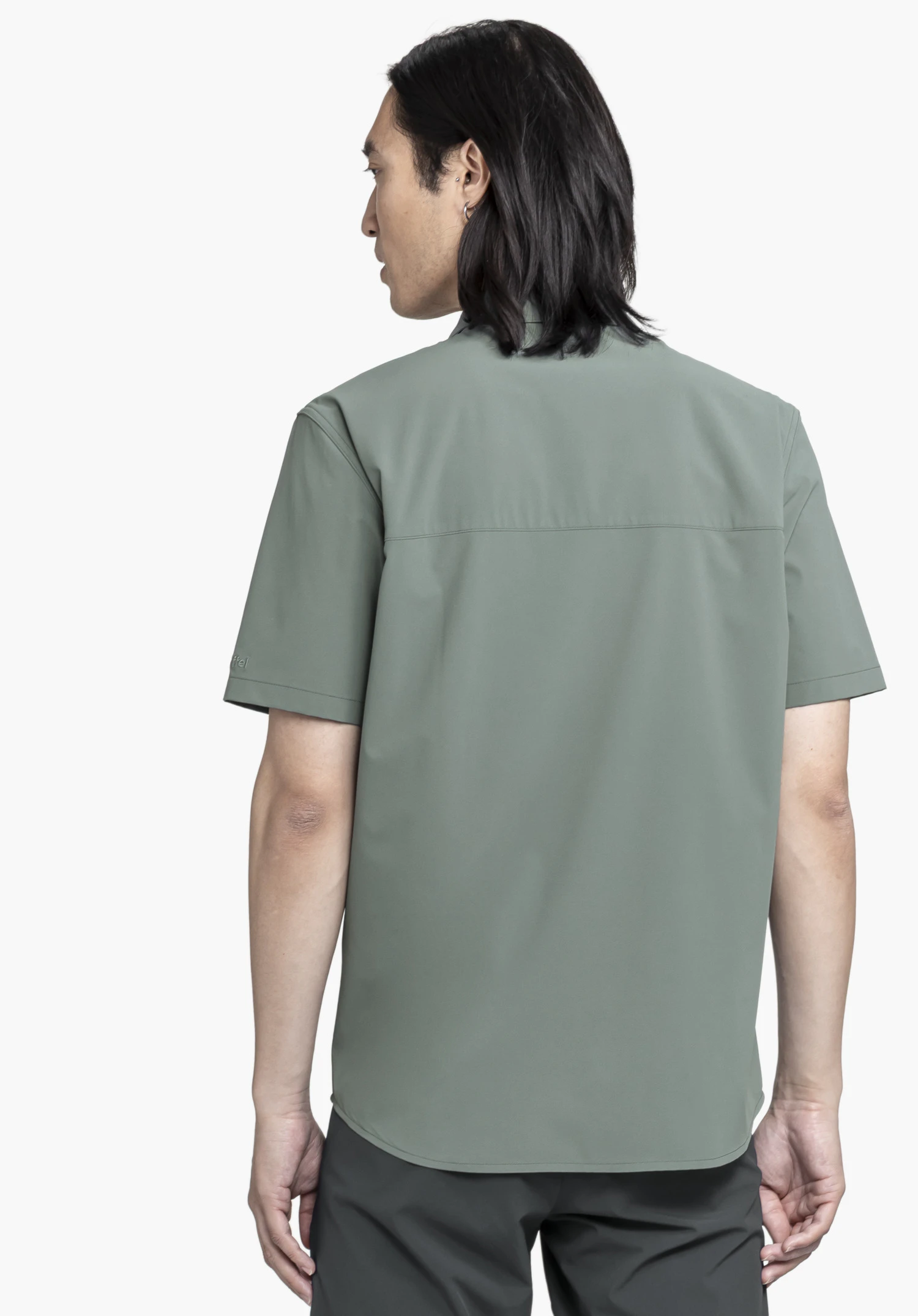 Shirt Style Dooser MEN in grey against a neutral background. The man is shown from the back, displaying the subtly embroidered Schöffel logo on the sleeve.