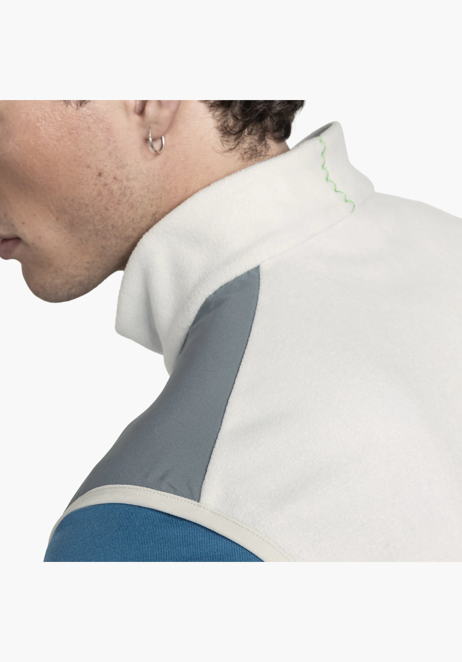 Fleece Vt Style Ash MEN shows the soft fleece material on the stand-up collar with a striking green zigzag stitch as a design feature, alongside a smooth, dark grey shoulder insert. Close-up against a white/neutral background.