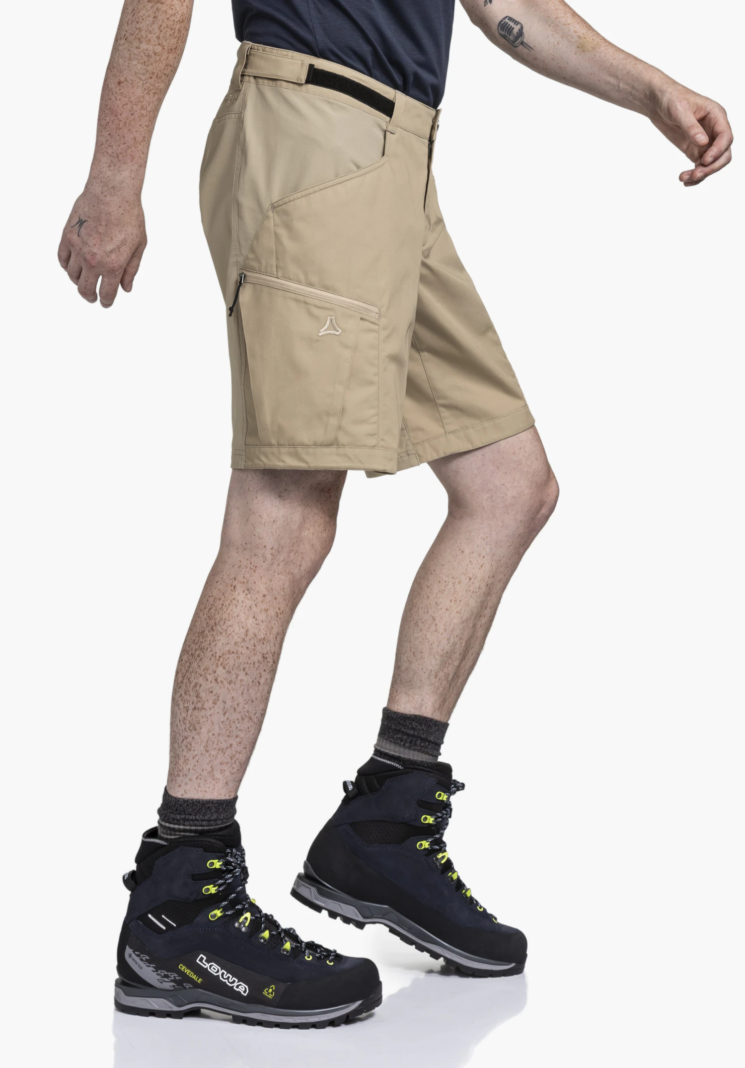 Shorts Style Maghera MEN in beige. A side-view model shot showing the shorts during a walking movement against a neutral background. The subtle Schöffel logo is clearly visible on the leg pocket.