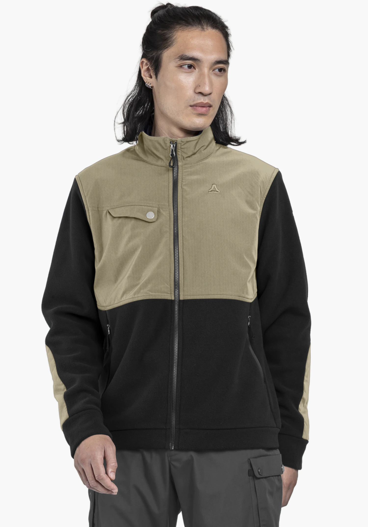 Fleece Jk Style Maghera MEN. Ein Model trägt die geschlossene Fleecejacke in der Farbe Schwarz und steht in Frontalansicht vor einem neutralen Hintergrund. Auf der linken Brust ist das Schöffel-Logo deutlich zu erkennen.