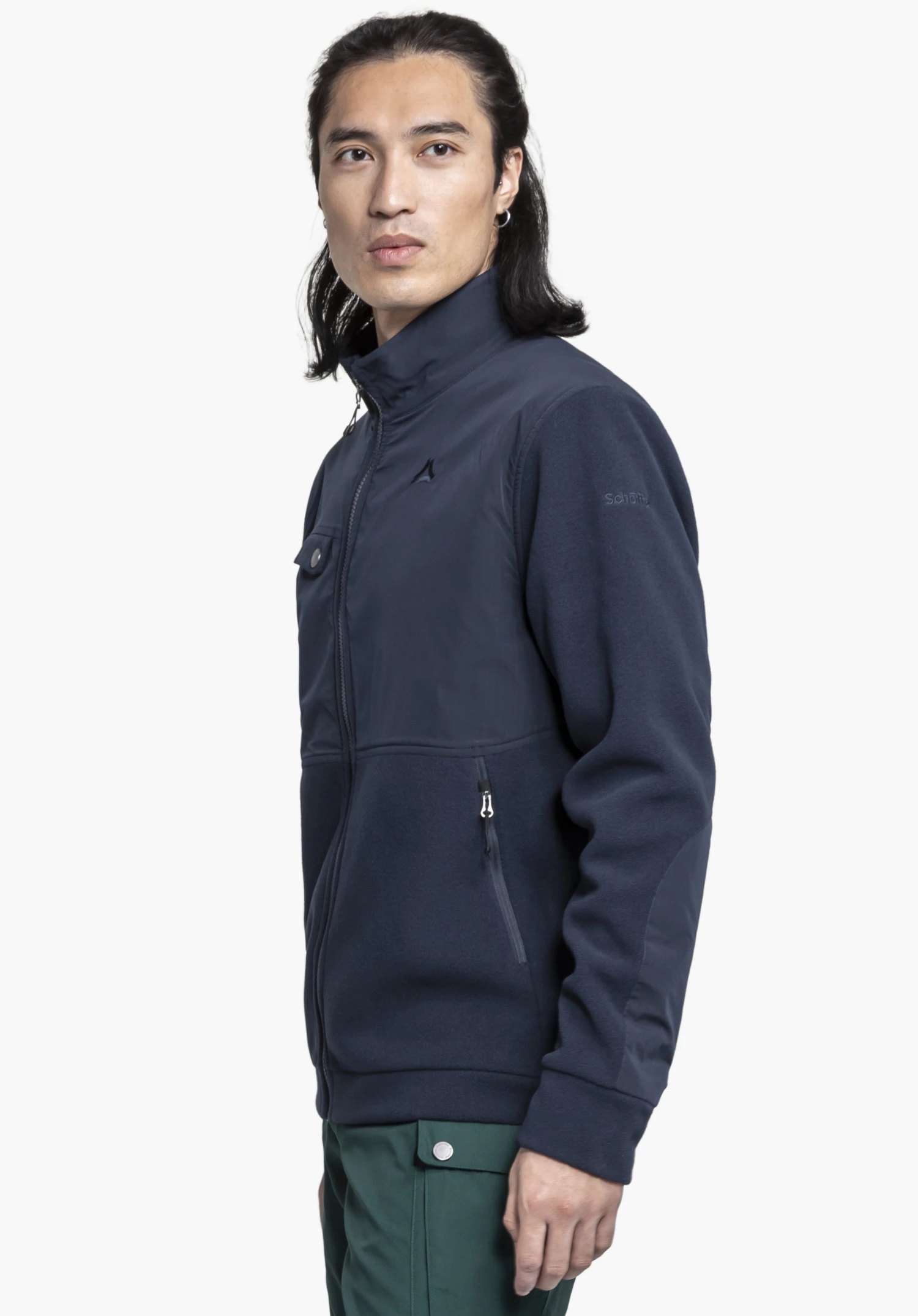 Fleece Jk Style Maghera MEN in blue: The model is standing sideways against a neutral background, showcasing the jacket. The subtle Schöffel logo is visible on the chest area as well as on the upper arm.