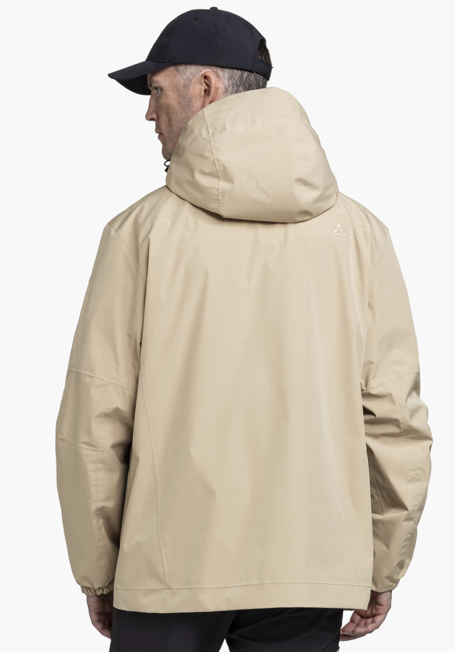 2L Jacket Style Maghera MEN in beige worn by a model in a back view. The Schöffel logo is subtly visible on the right rear shoulder area, photographed against a neutral background.