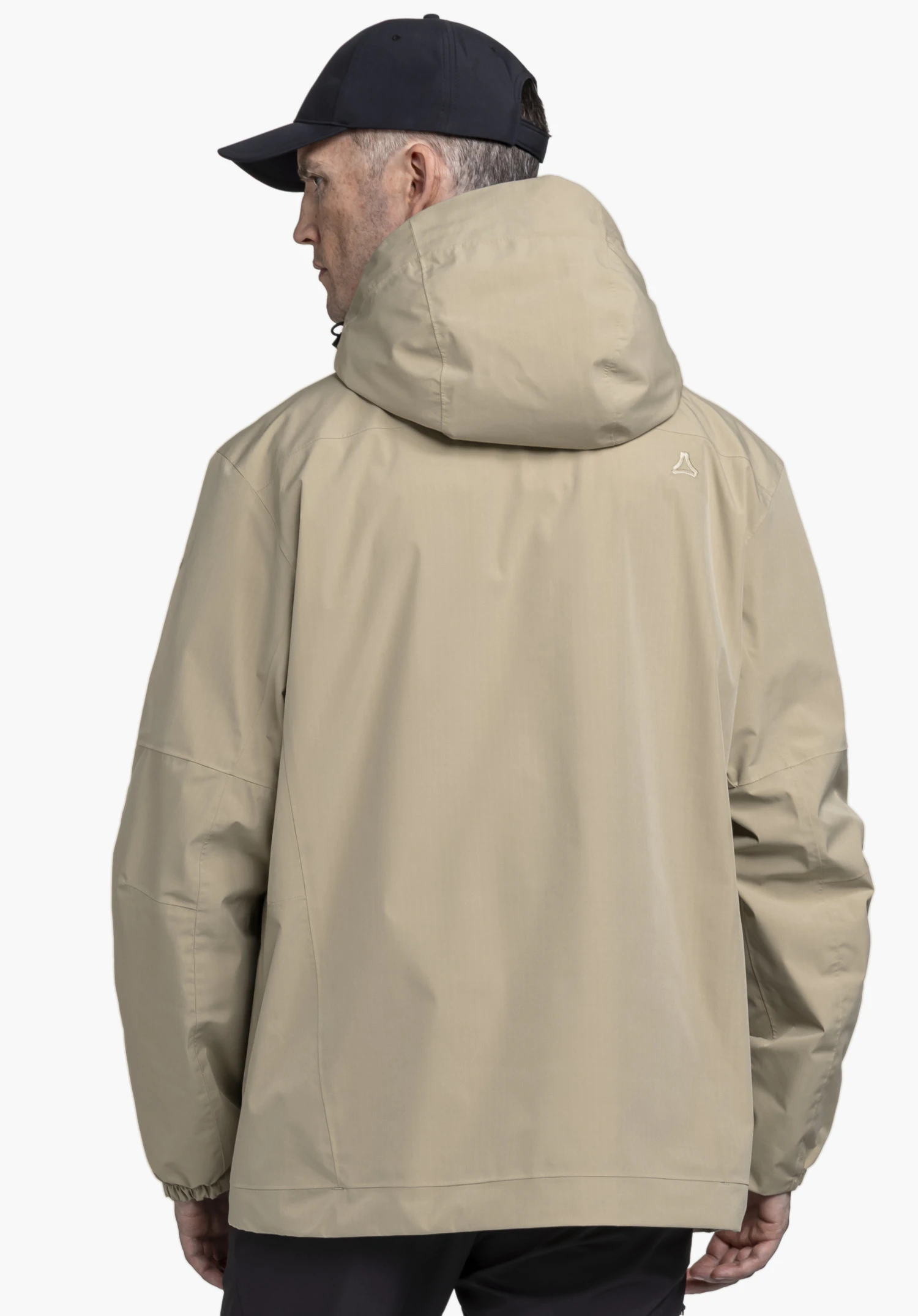2L Jacket Style Maghera MEN worn by a model in a back view. The beige jacket features a hood and a visible Schöffel logo on the right shoulder. The model stands in front of a neutral background.