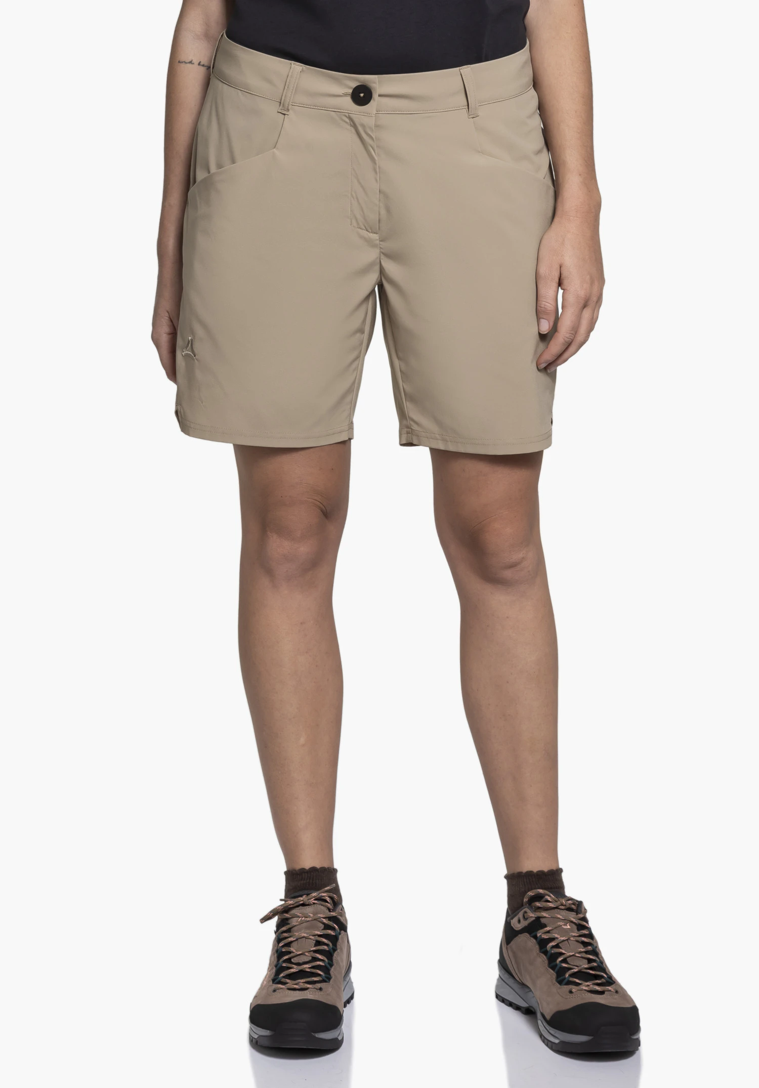 CIRC Shorts Style Smue WMN in beige, worn by a model facing forwards. You can see the shorts with side pockets and the Schöffel logo on the right leg. The model stands upright against a neutral background, paired with a dark top and walking boots.