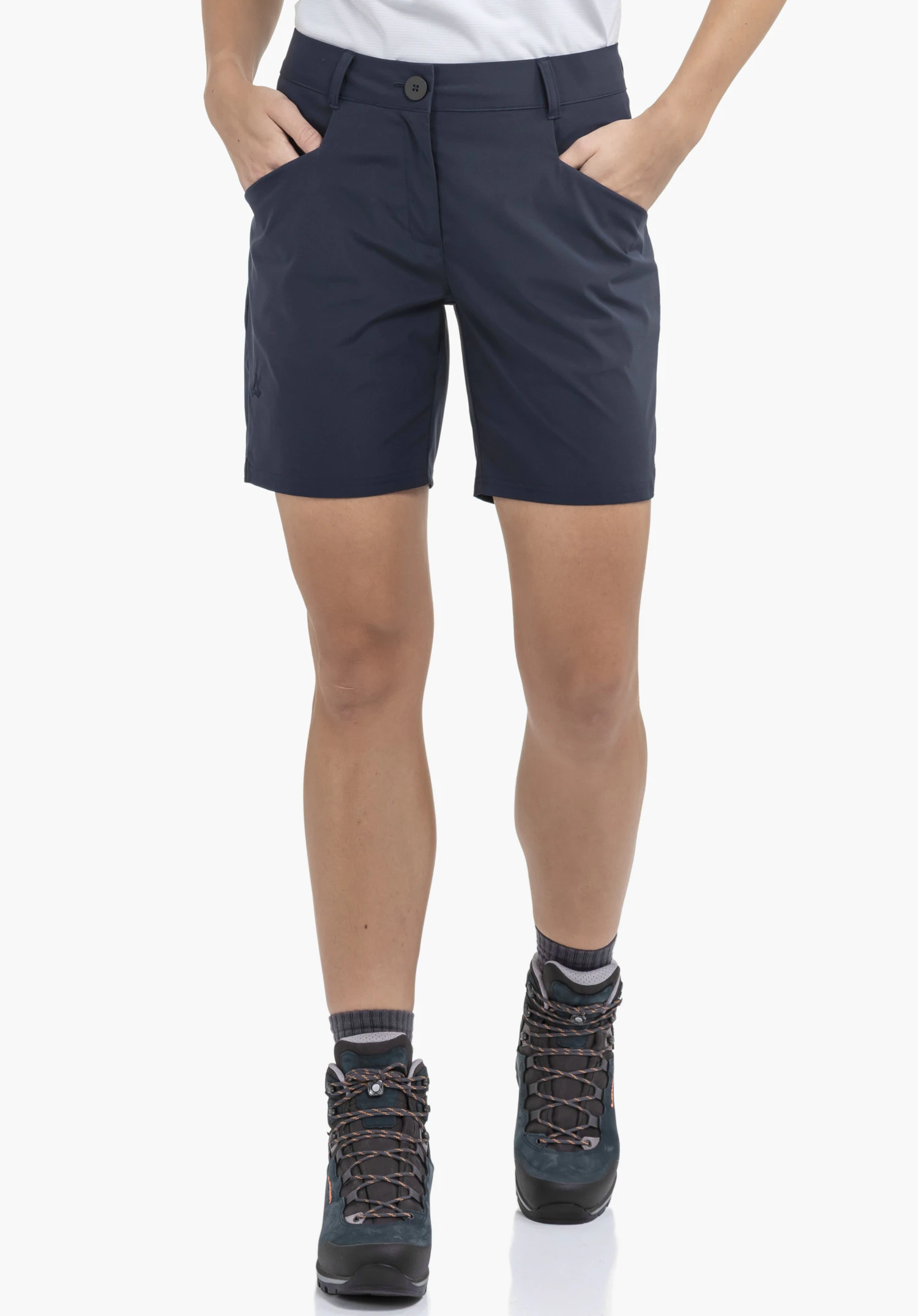 CIRC Shorts Style Smue WMN worn by a model standing front on with both hands in the pockets of the blue shorts. A subtle Schöffel logo is visible on the right leg, presented against a neutral background.
