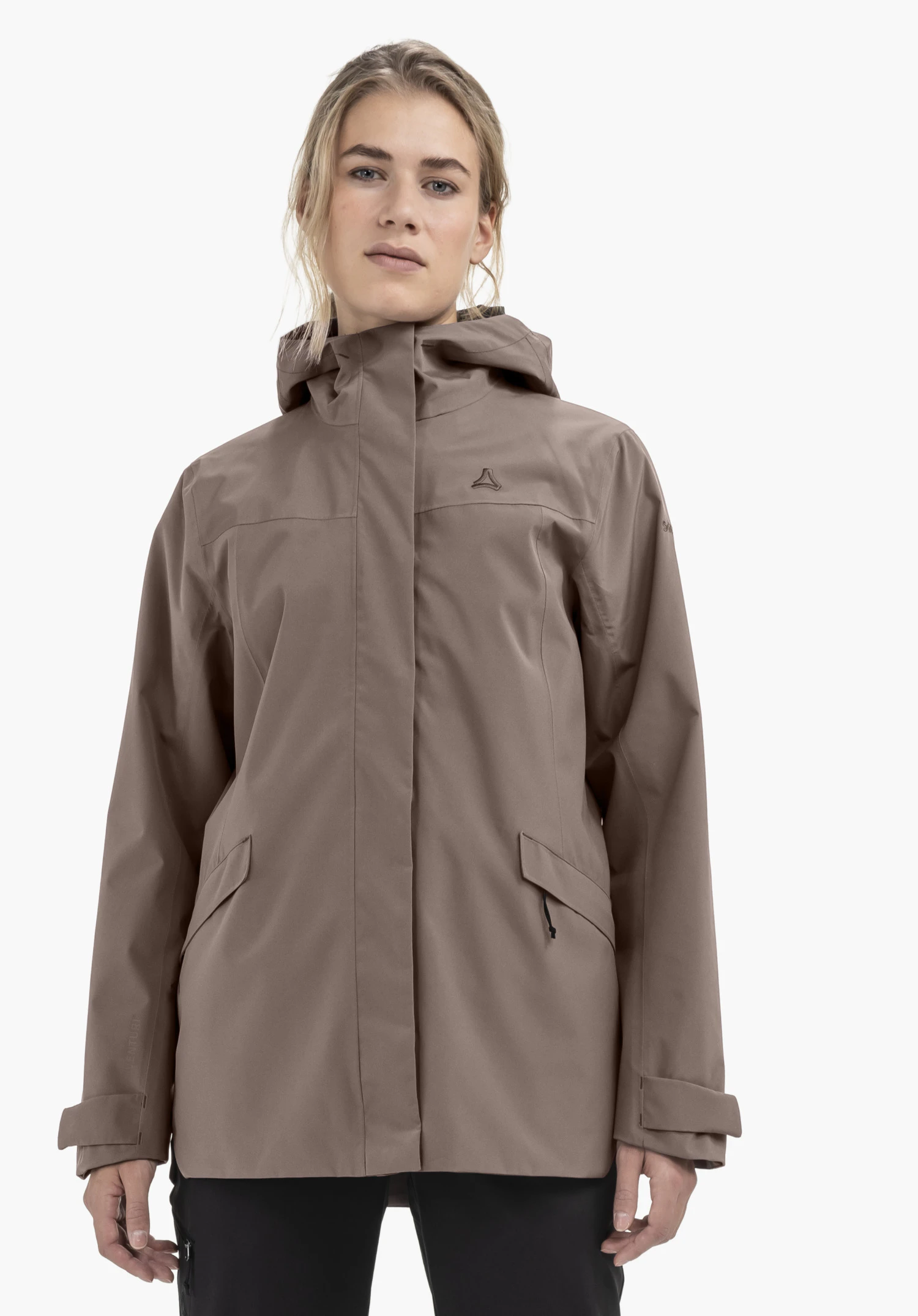 CIRC Jacket Style Smue WMN. A model stands facing forward wearing the brown jacket with a visible Schöffel logo on the left chest, against a neutral background.