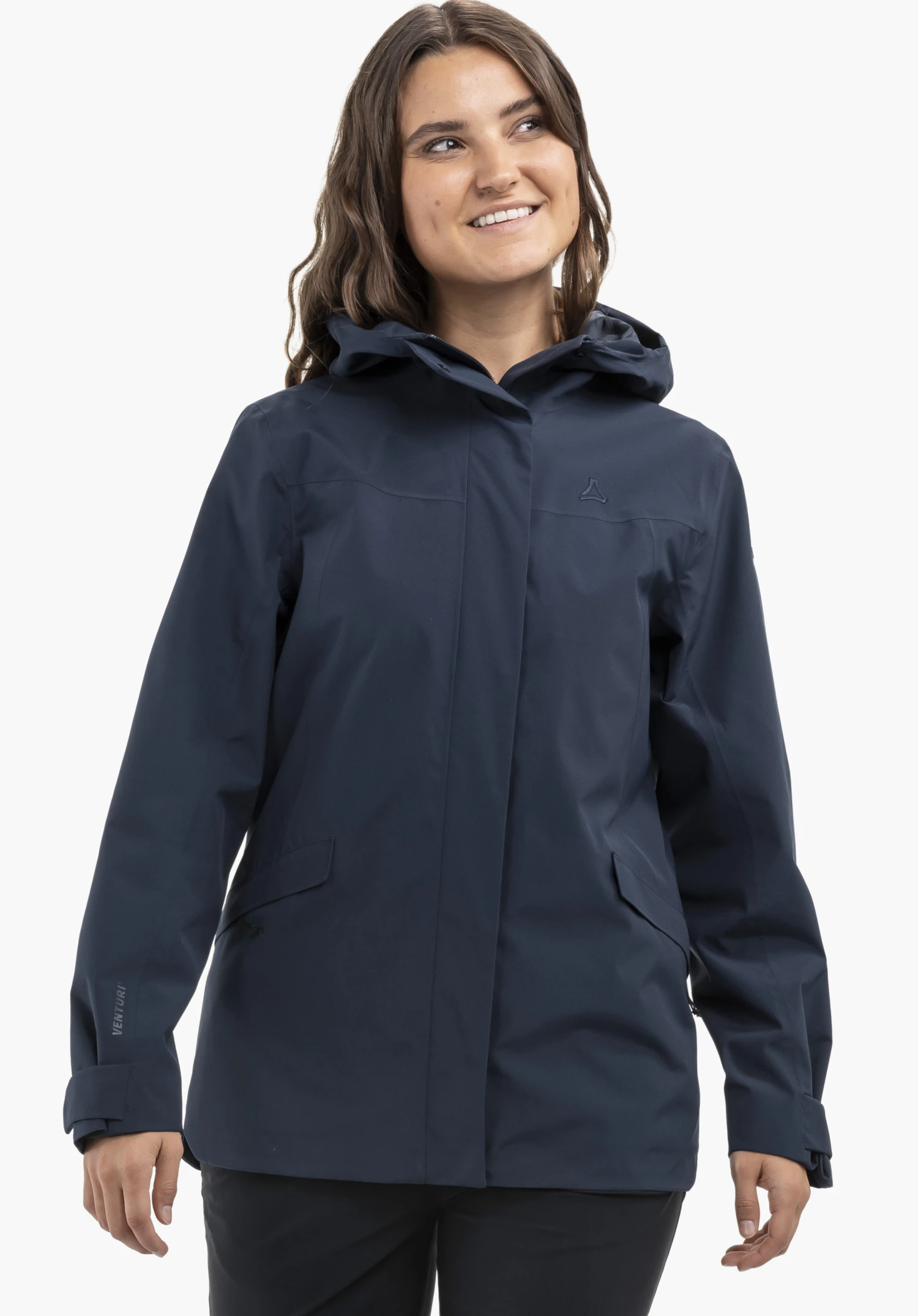 CIRC Jacket Style Smue WMN in blue, worn by a smiling model standing frontally. The jacket features a hood as well as the Schöffel-Logo on the left chest, presented against a neutral background.