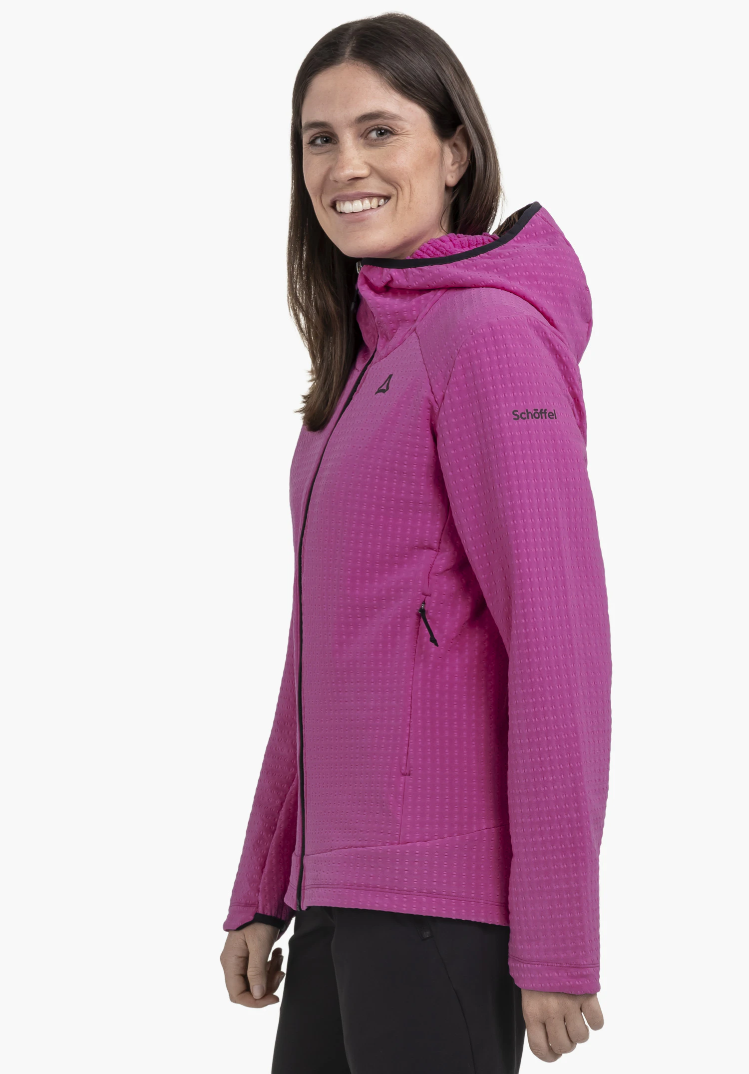 Fleece Hoody Style Enixa WMN in Pink an einem Model, das seitlich steht. Man sieht die Fleecejacke mit schwarzem Reißverschluss und dem Schöffel-Logo auf Brust und Ärmel vor einem neutralen Hintergrund.
