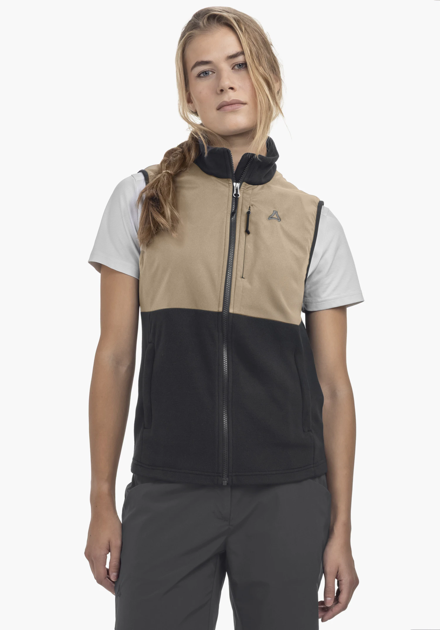 Fleece Vt Style Ash WMN on a model standing frontally. The gilet features a colour-block design with the lower section in black and a visible Schöffel logo on the left chest. It is worn over a light t-shirt and presented against a neutral background.