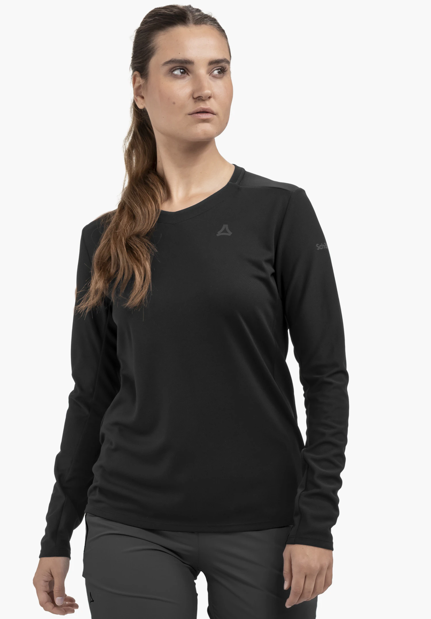 Longsleeve Style Enixa WMN in black, worn by a model. The Schöffel logo is visible on the left chest and the model stands frontally in front of a neutral background.