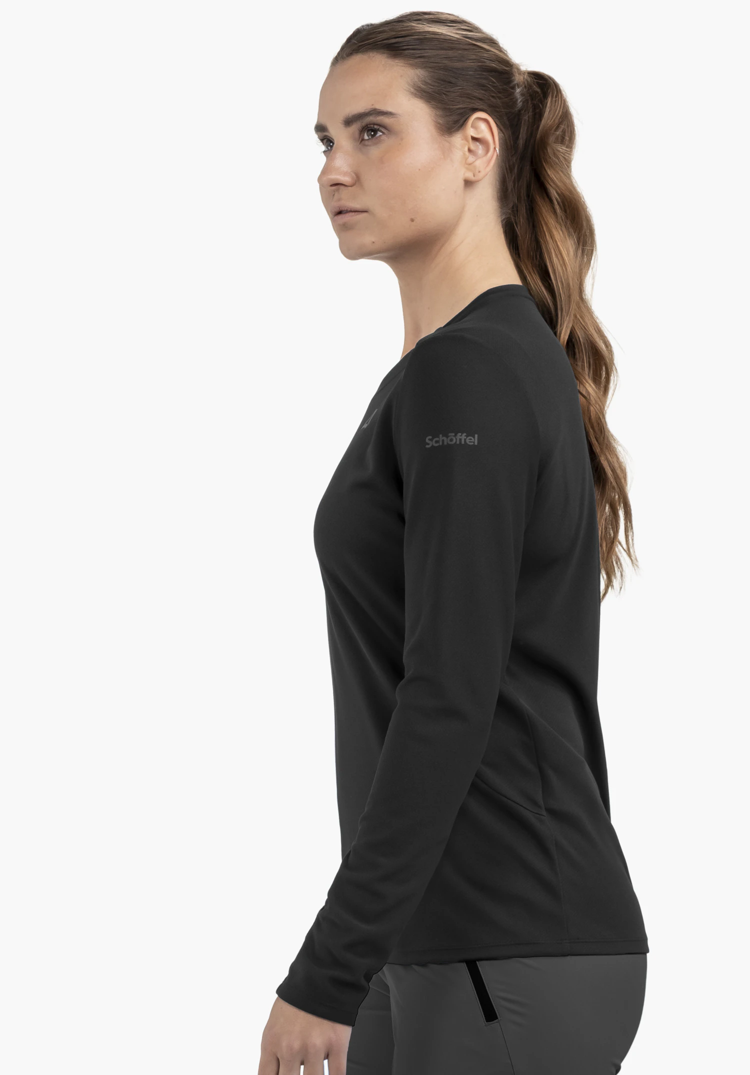 Longsleeve Style Enixa WMN in black, worn by a model standing sideways with the Schöffel-Logo visible on the arm, against a neutral background.